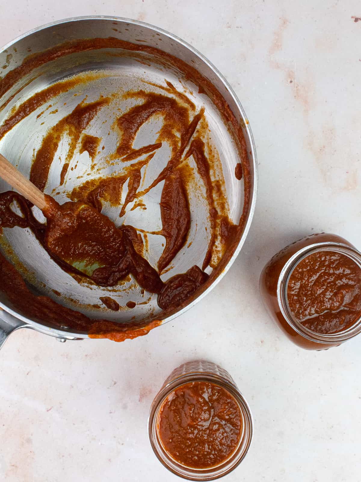 Two jars are filled with finished pumpkin butter