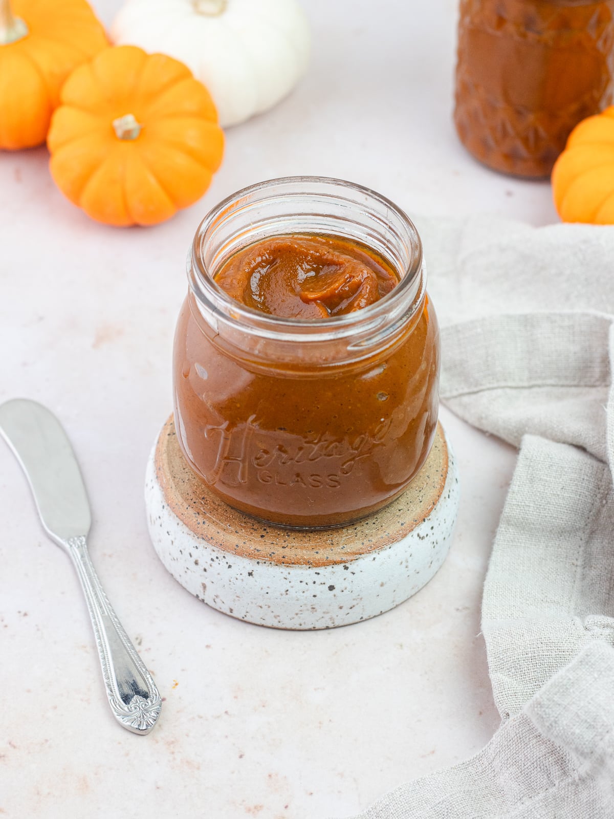 Pumpkin butter in a jar with tiny pumpkins