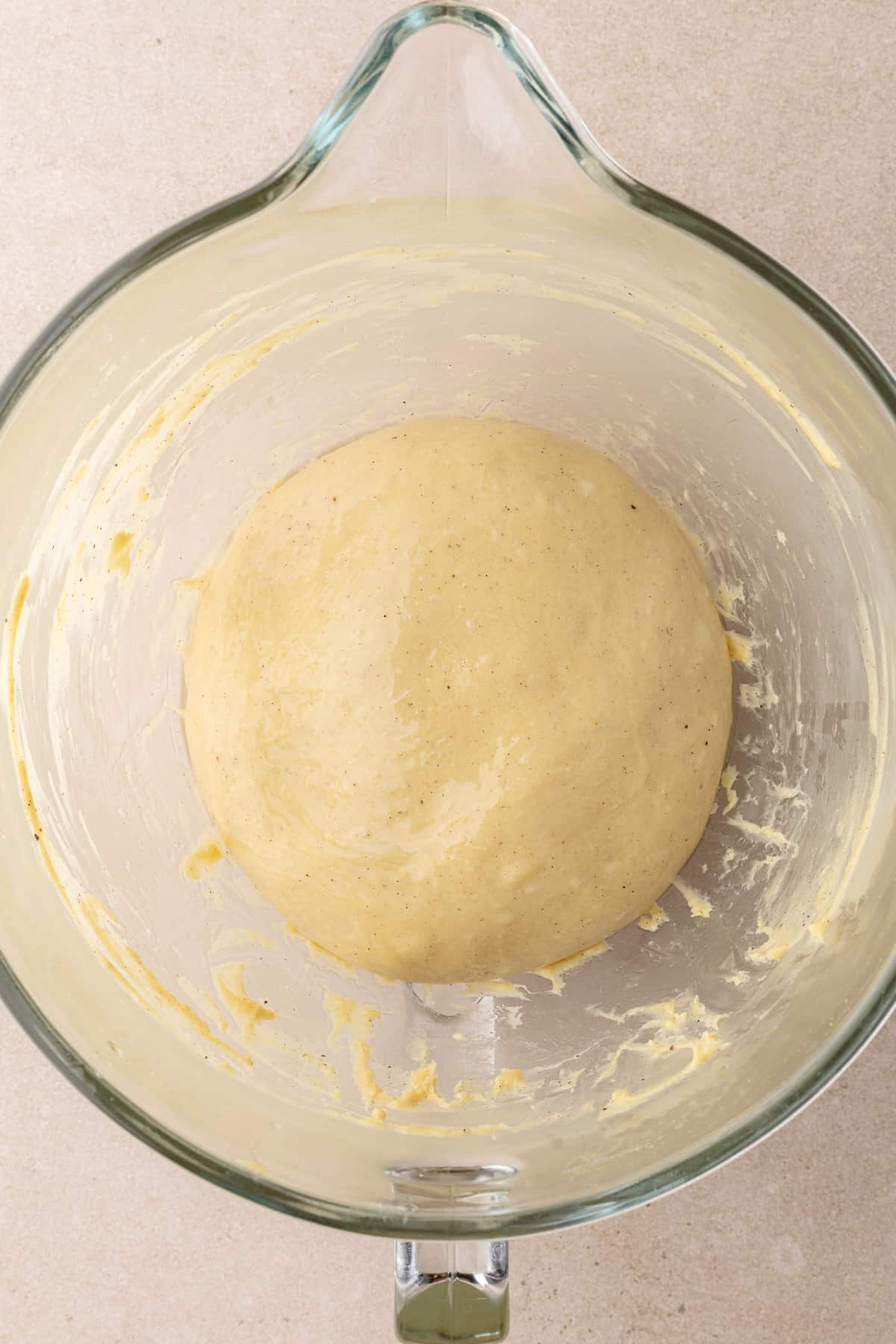 Oiled dough sits inside an oiled bowl