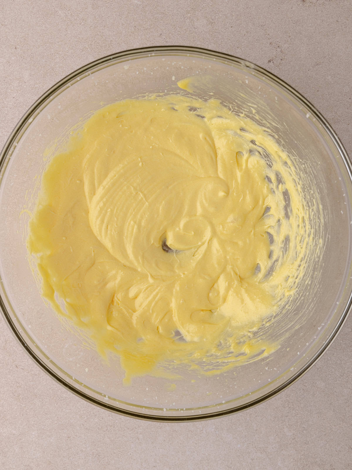 Two egg yolks are whisked until light and fluffy.