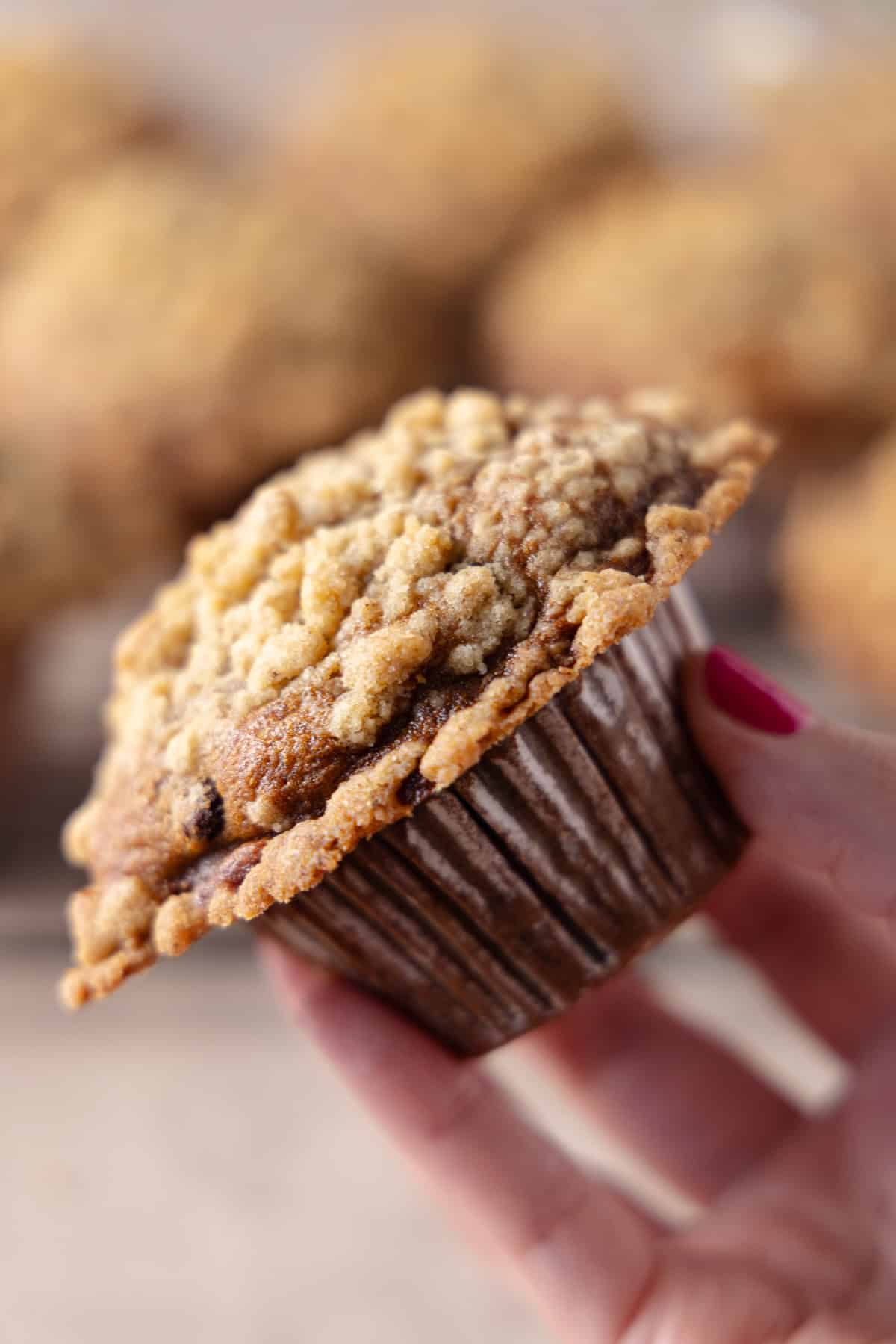 A hand holding a Banana Espresso Muffin.