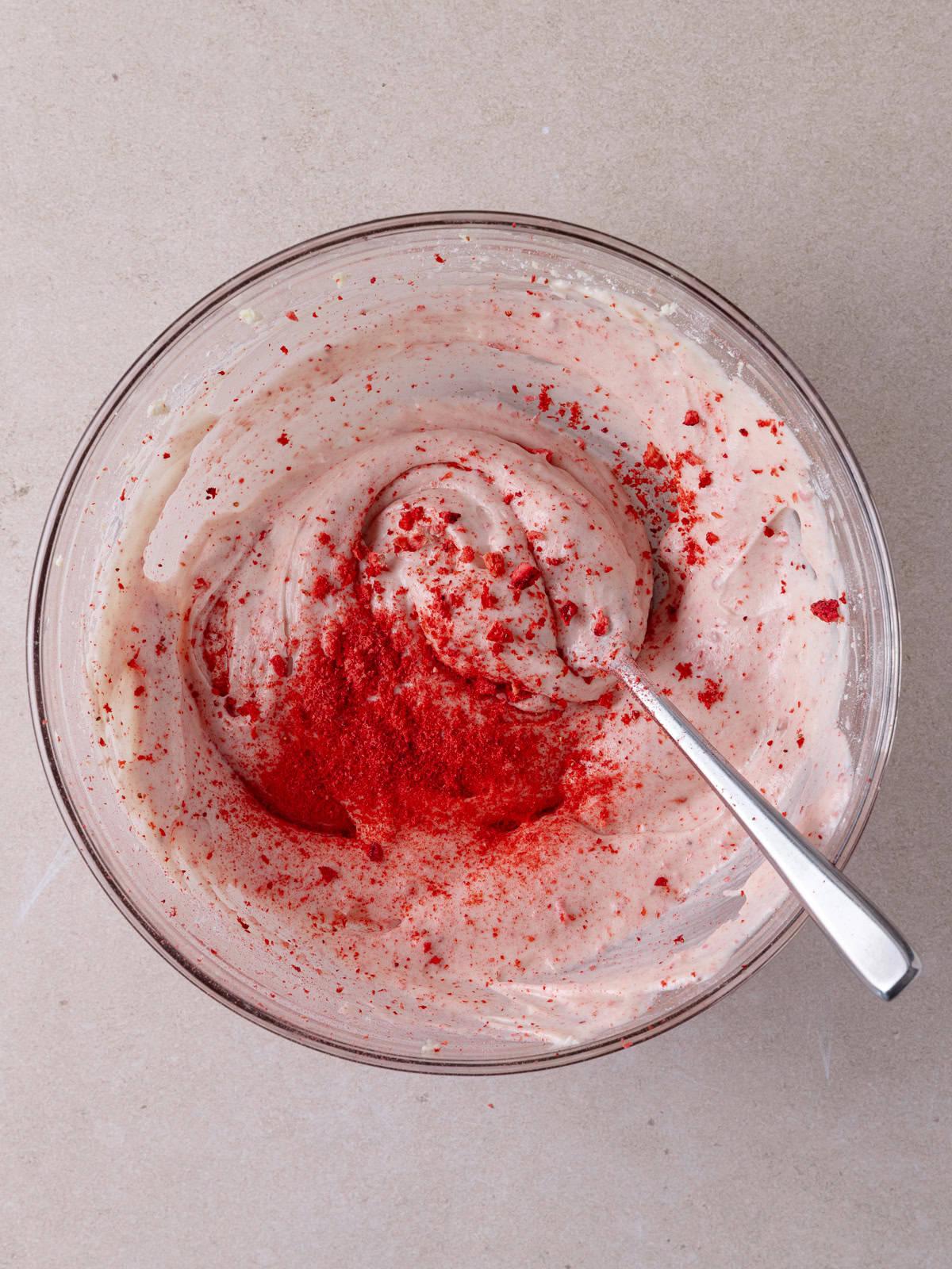 Strawberry cream cheese frosting in a small glass bowl.