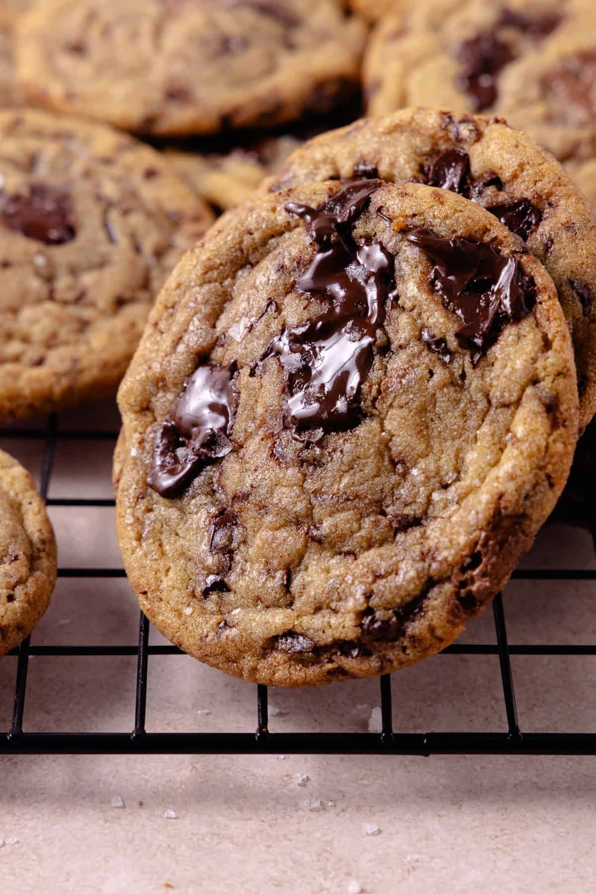 Close up of brown butter chocolate chip cookies on a wire rack.