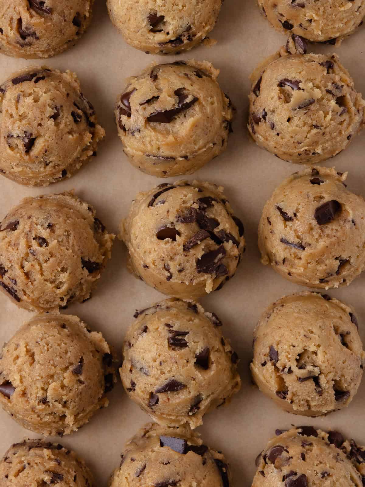 Cookies dough is scooped onto a small baking sheet.