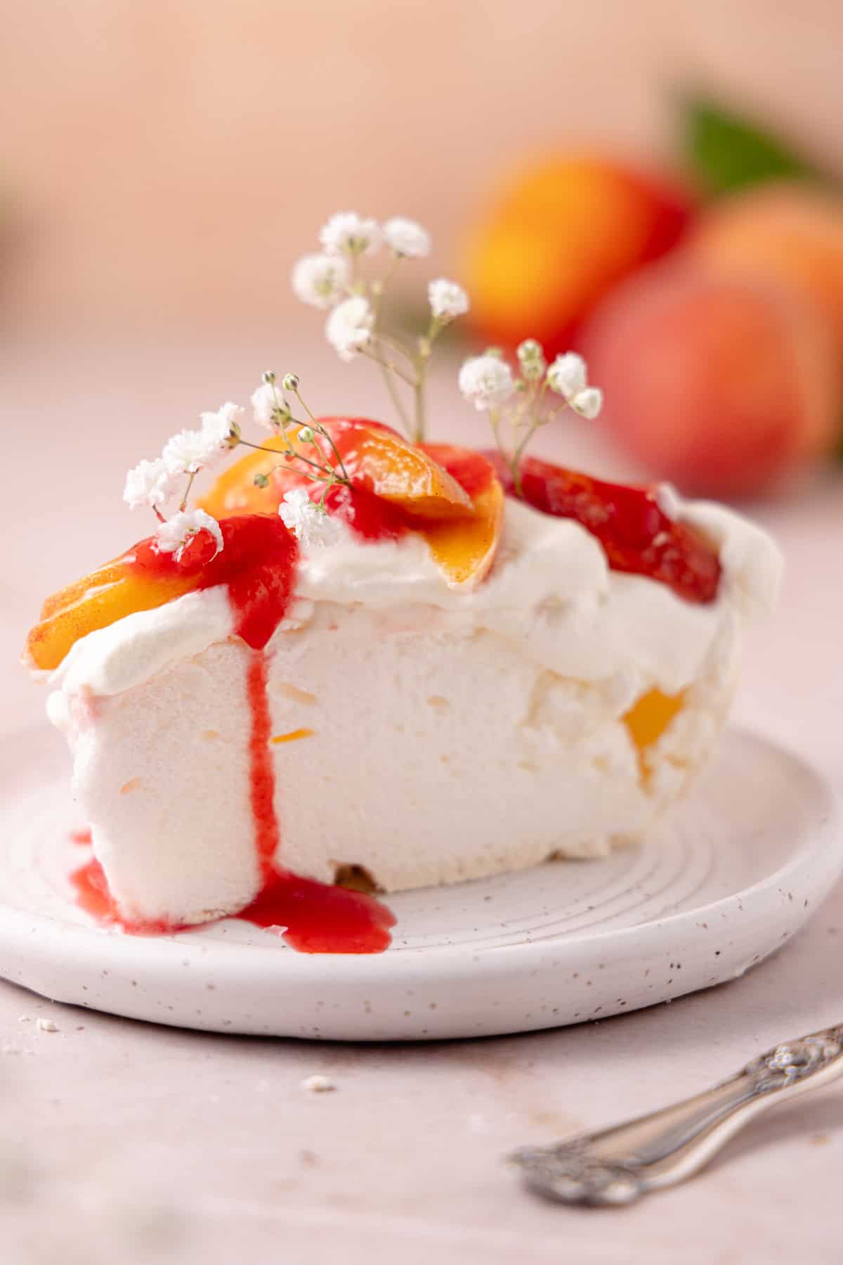 A slice of pavlova is on a plate.