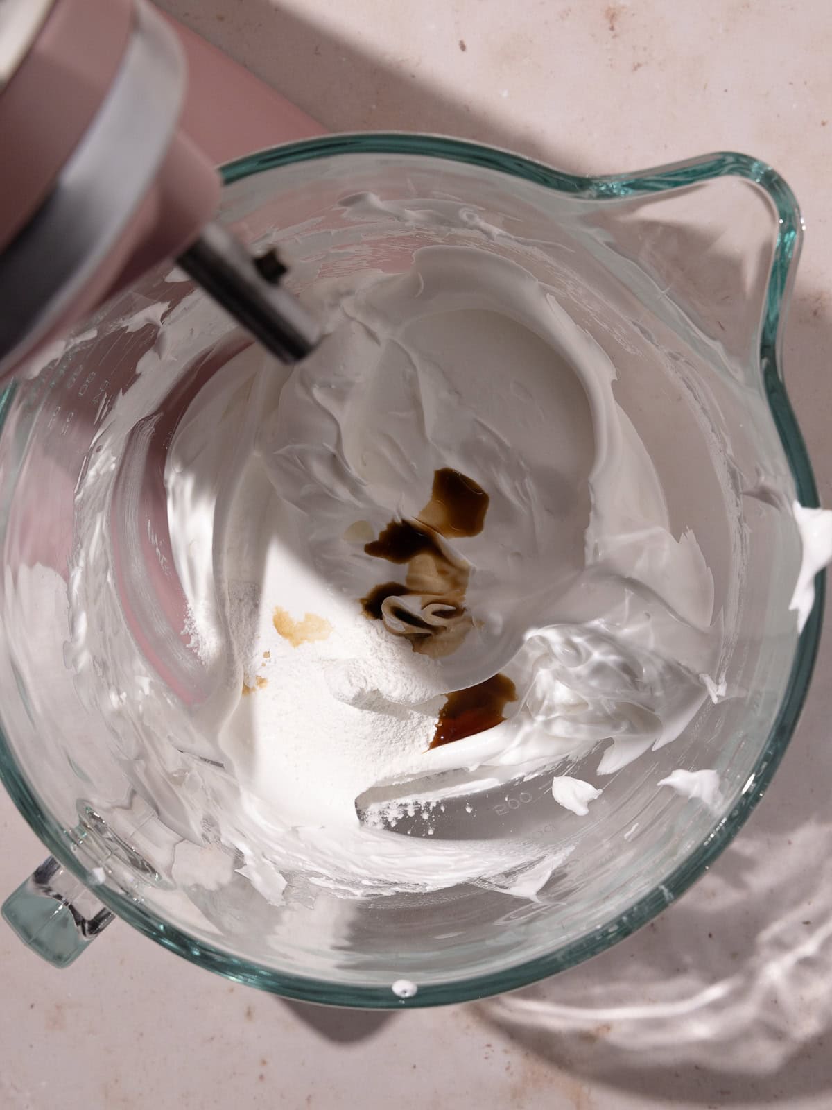 Sifted cream of tartar, cornstarch and vanilla are added to the whipped meringue.