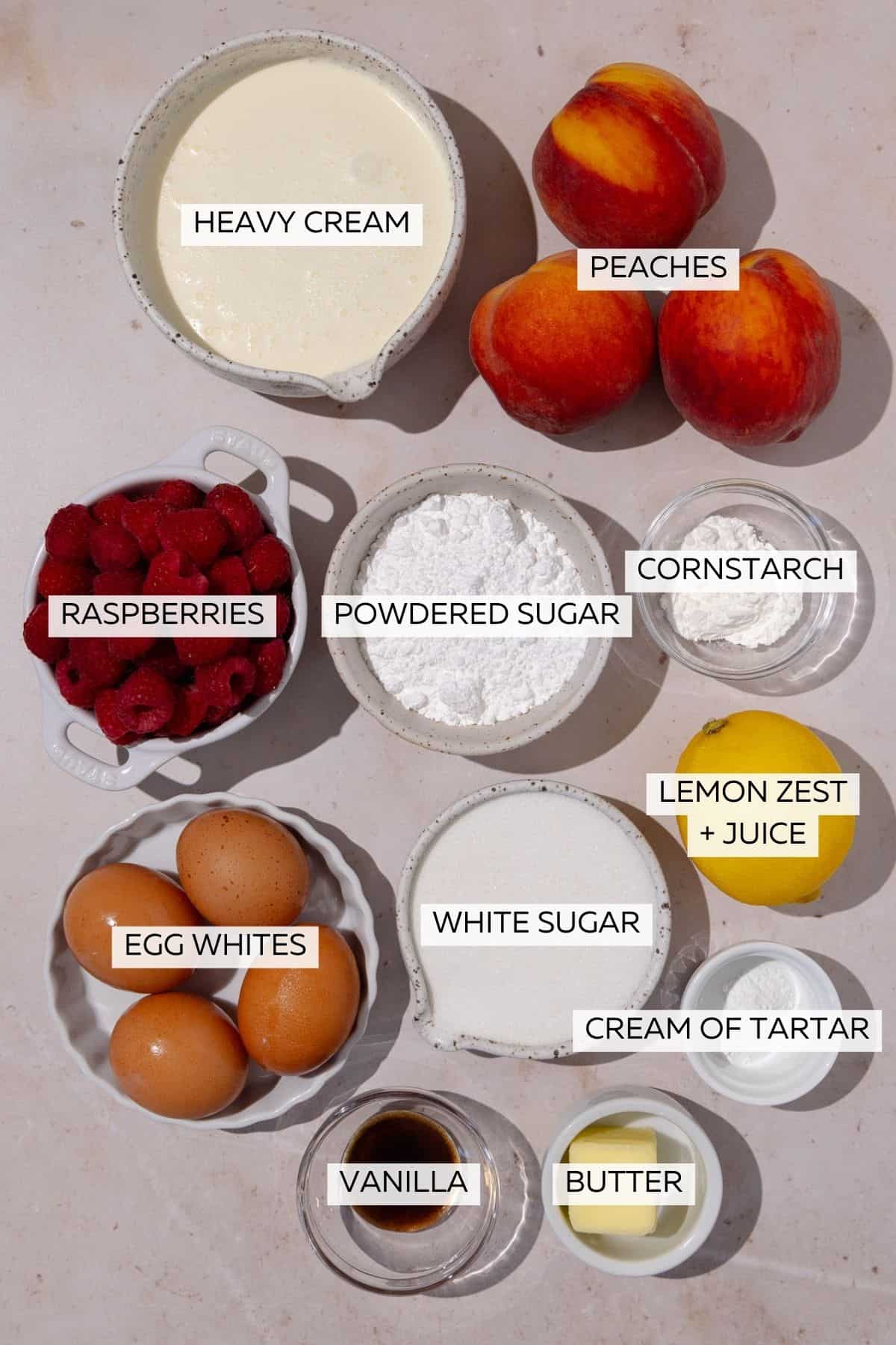 Pavlova melba pavlova ingredients, which include egg white, powdered sugar, white sugar, peaches, raspberries, butter, heavy cream, cornstarch, cream of tartar and vanilla.