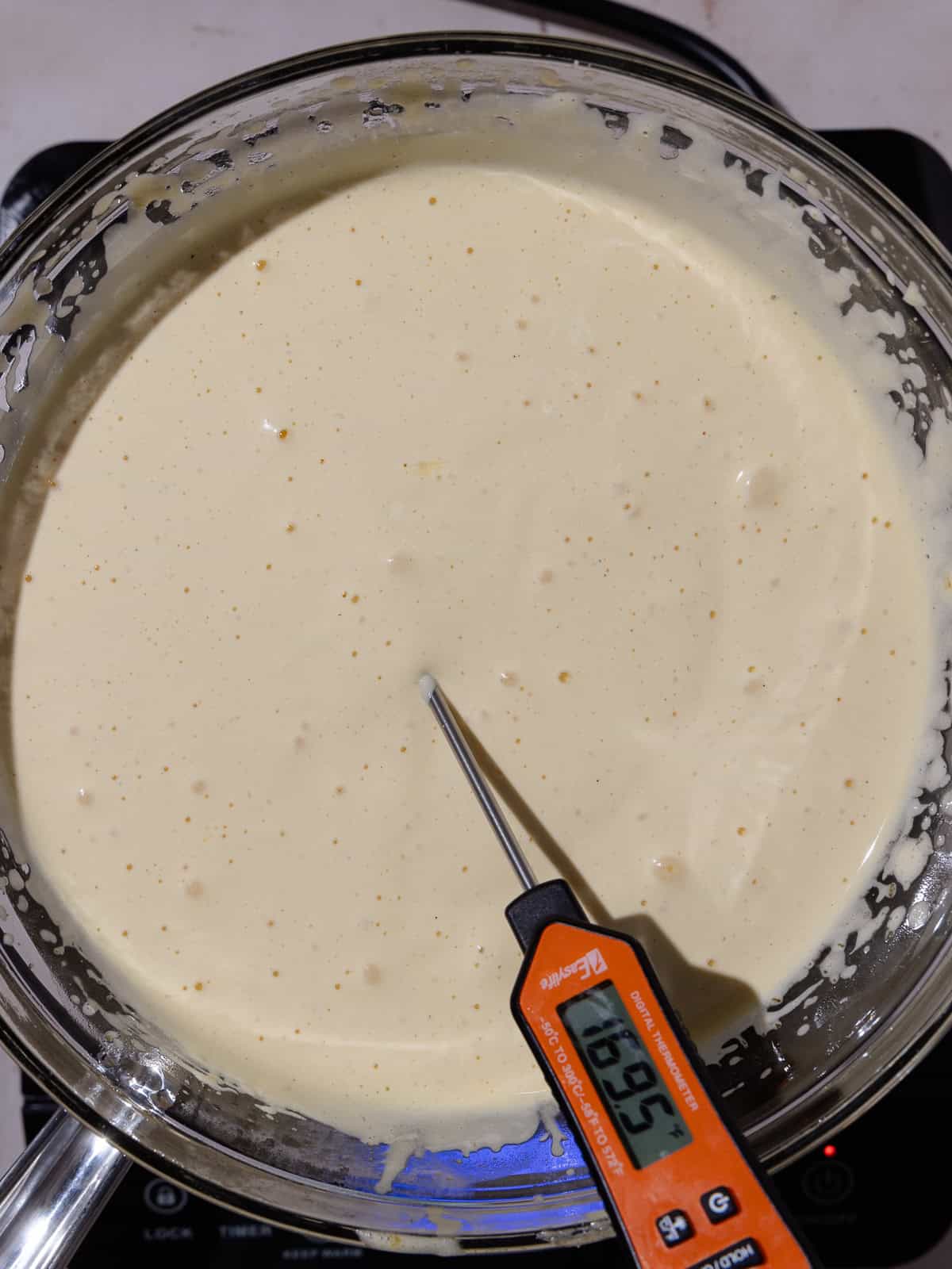 Whipped yolk/condensed milk mixture is cooked until about 170 degrees fahrenheit.