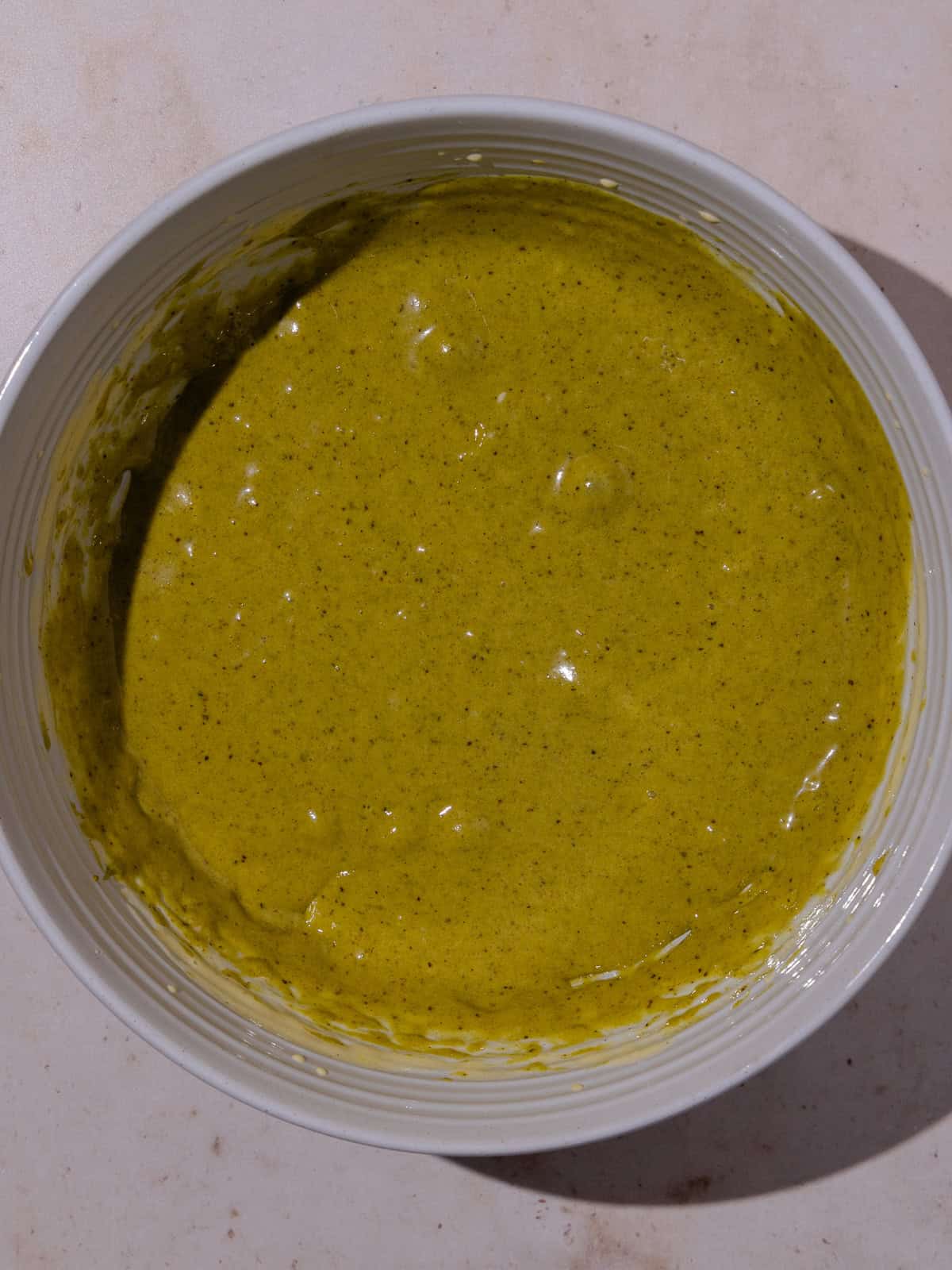 Pistachio paste and egg yolk mixture is combined.