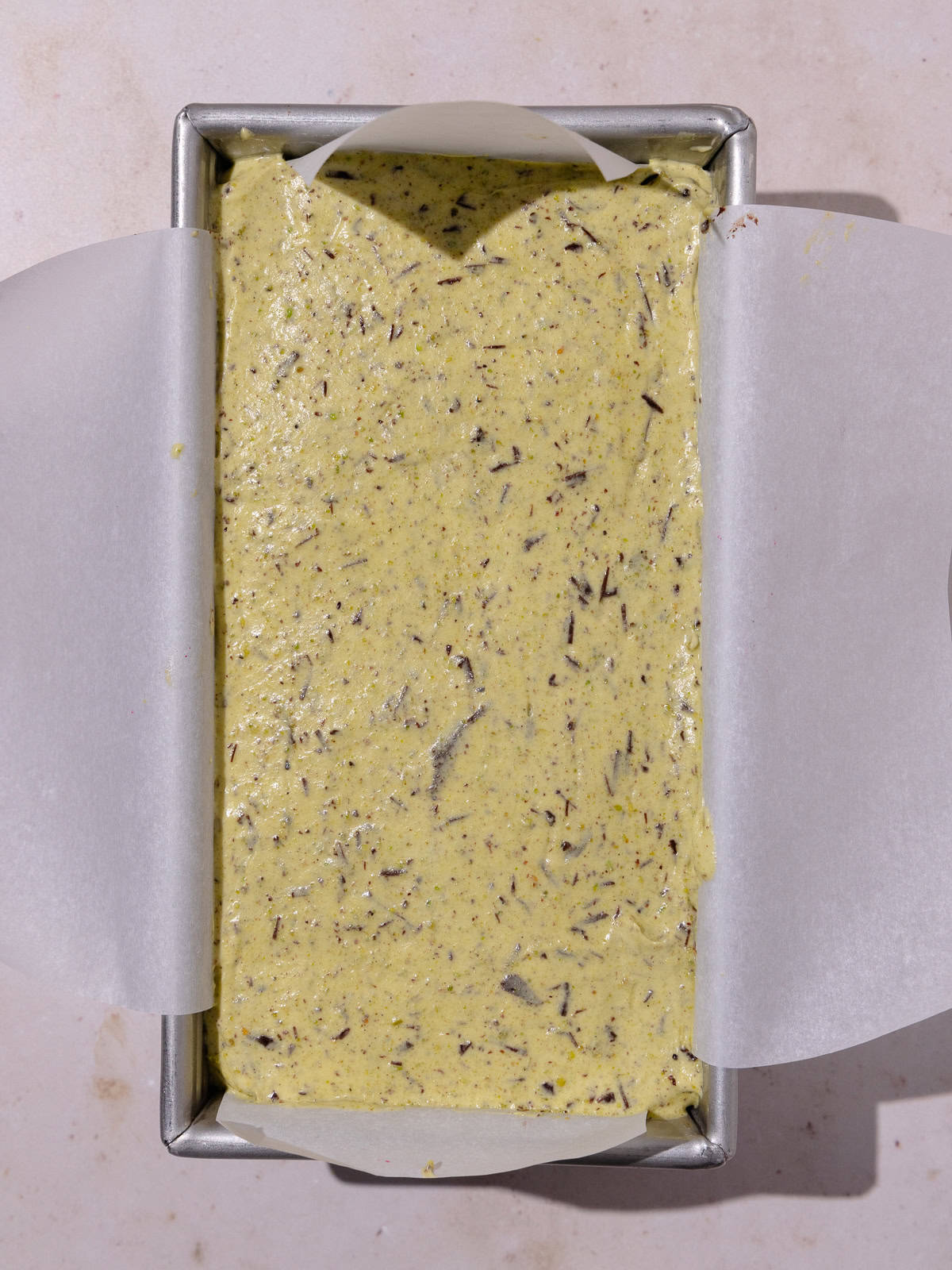 Pistachio Semifreddo base is poured into load pan.