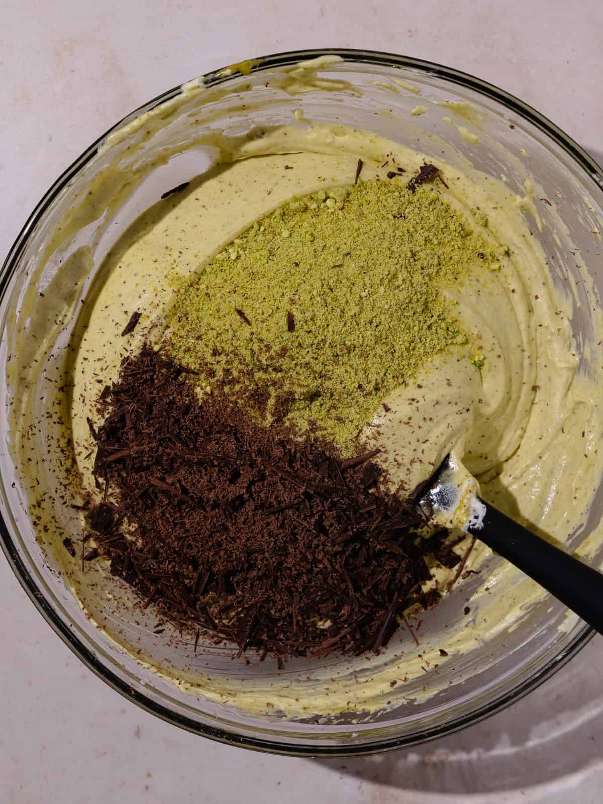 Ground pistachios and finely chopped chocolate is added to the base mixture.