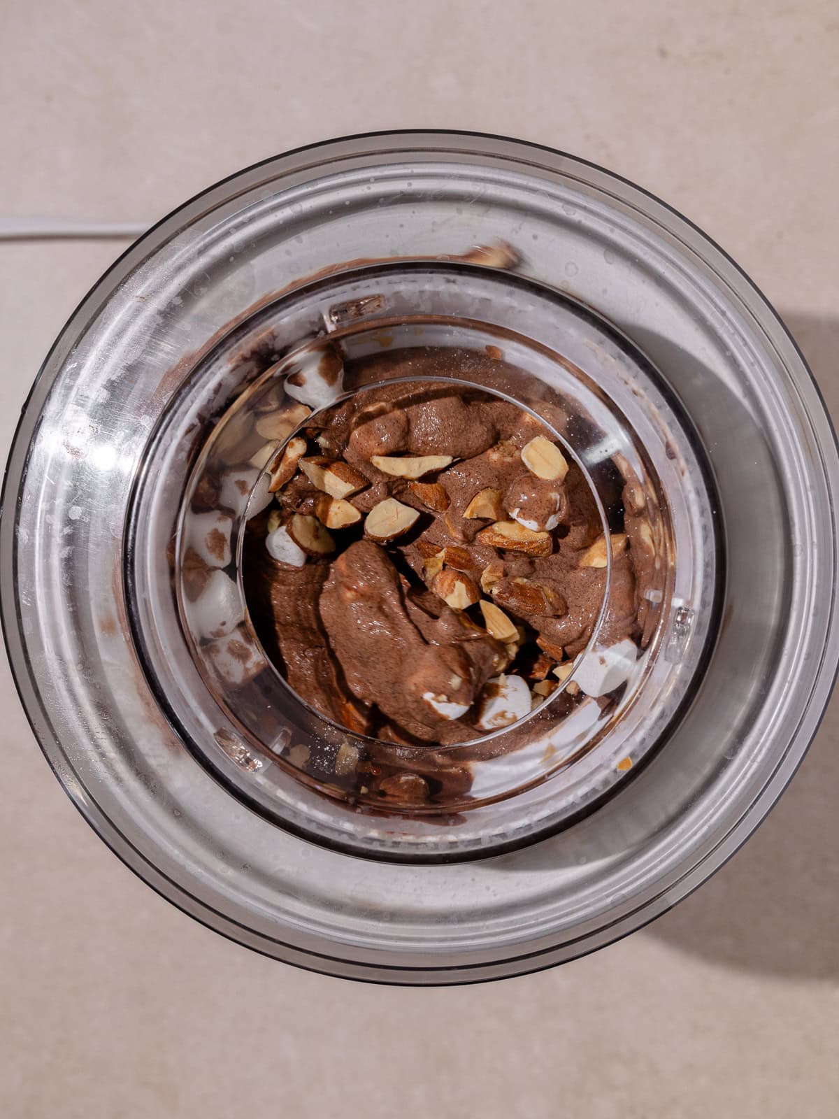 Ice Cream churned in ice cream machine. Almonds, marshmallows and finely chopped chocolate is added to the ice cream.