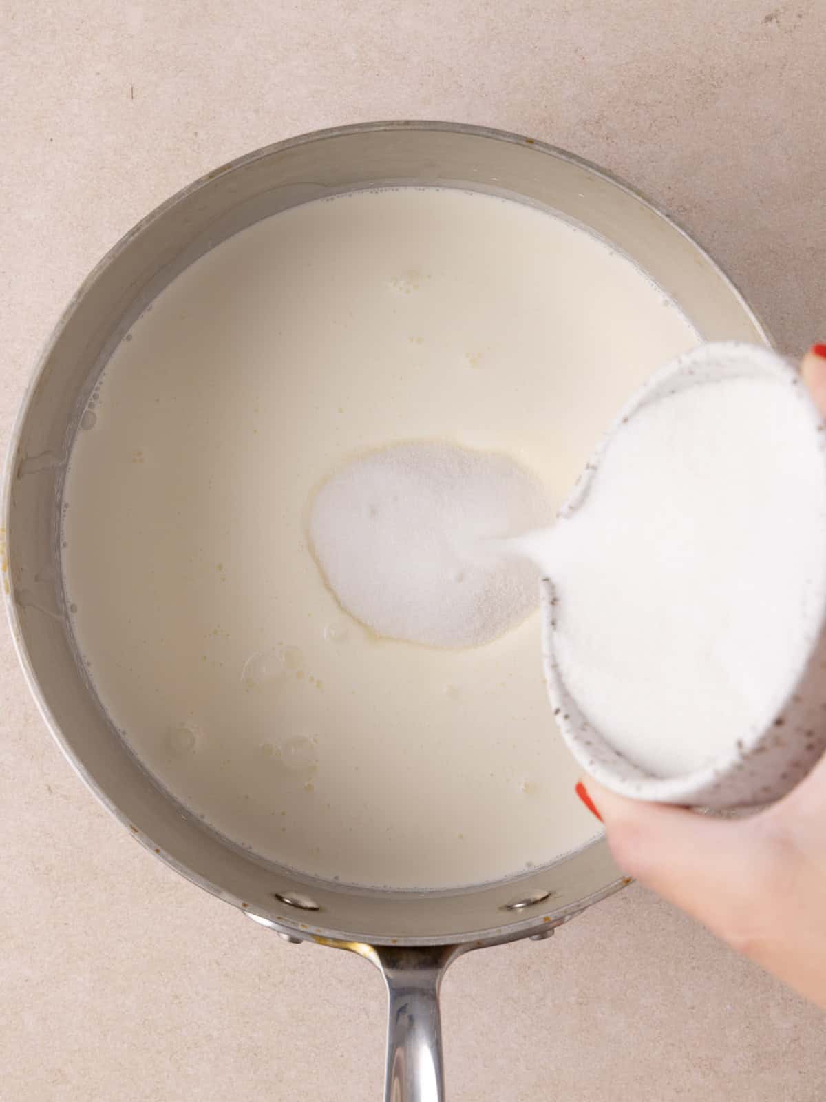 Heavy cream, milk and sugar is added to a medium saucepan.