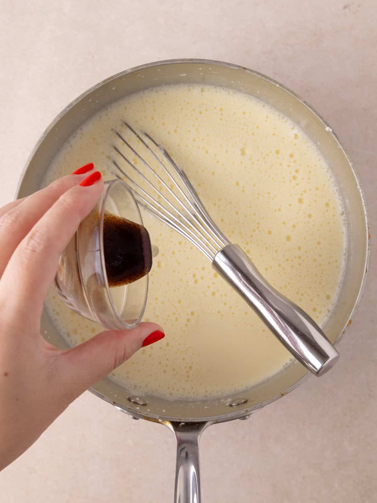 Vanilla is poured into the pot with the custard.