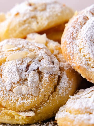 A pile of almond croissant muffins featured photo.