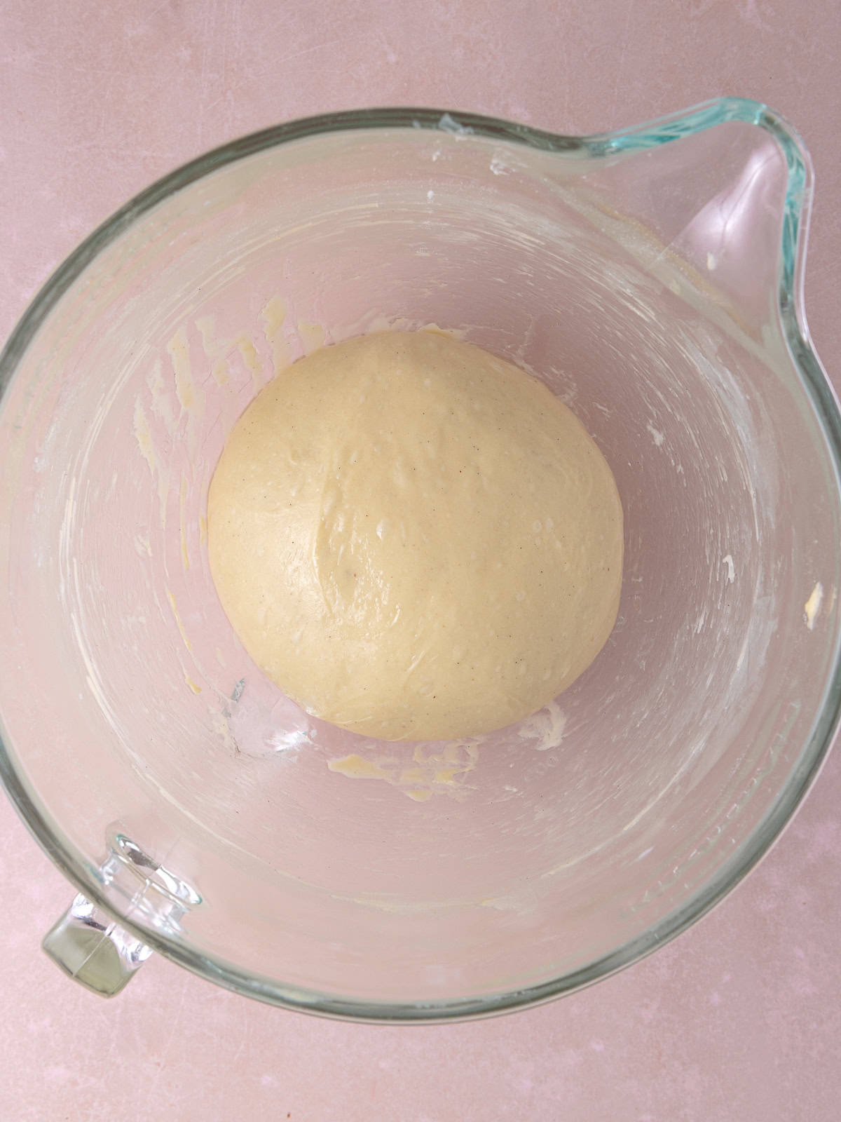 Dough is formed into a smooth ball and placed in an oiled bowl.