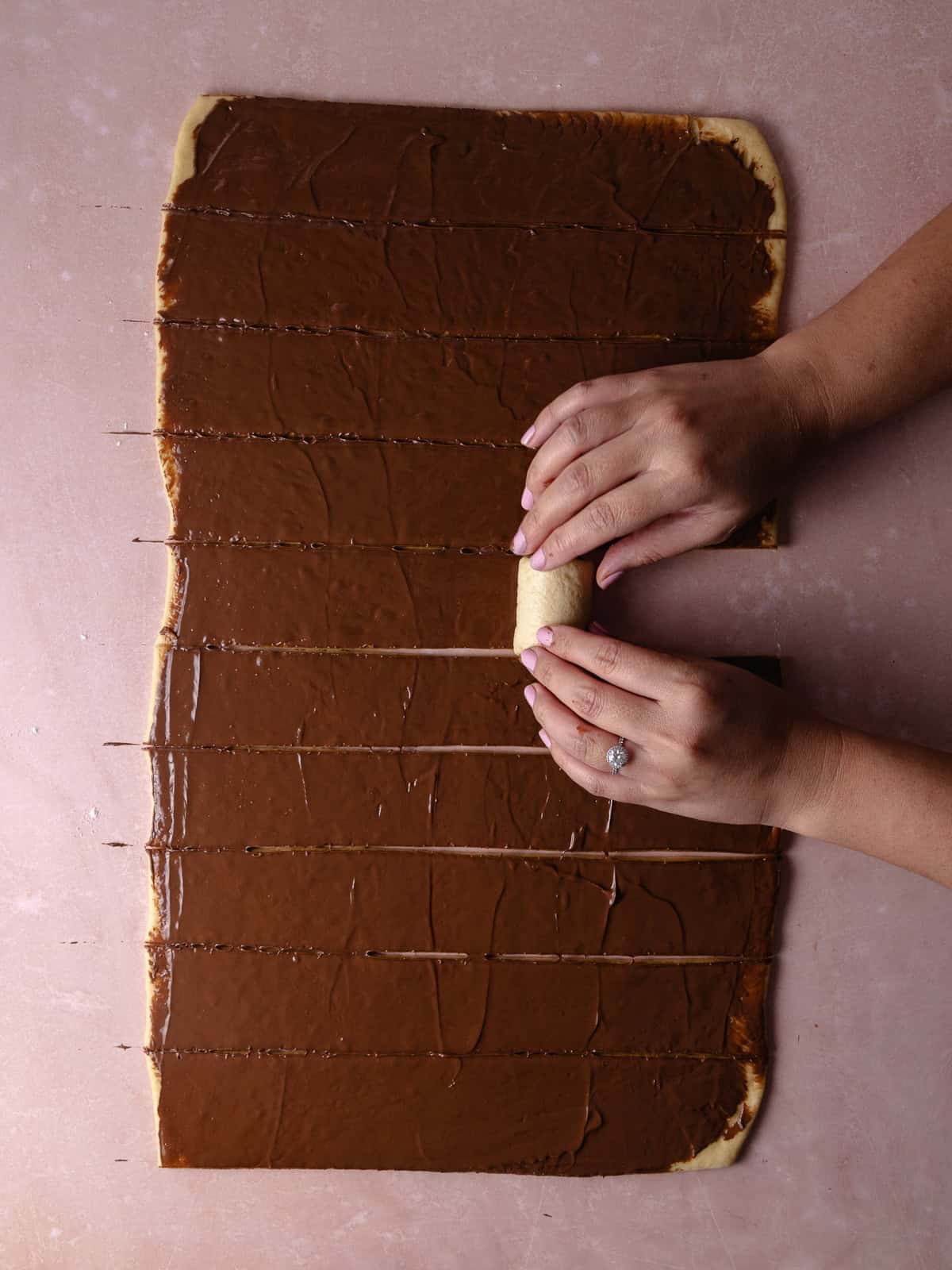 The dough is cut into strips and then rolled into buns.