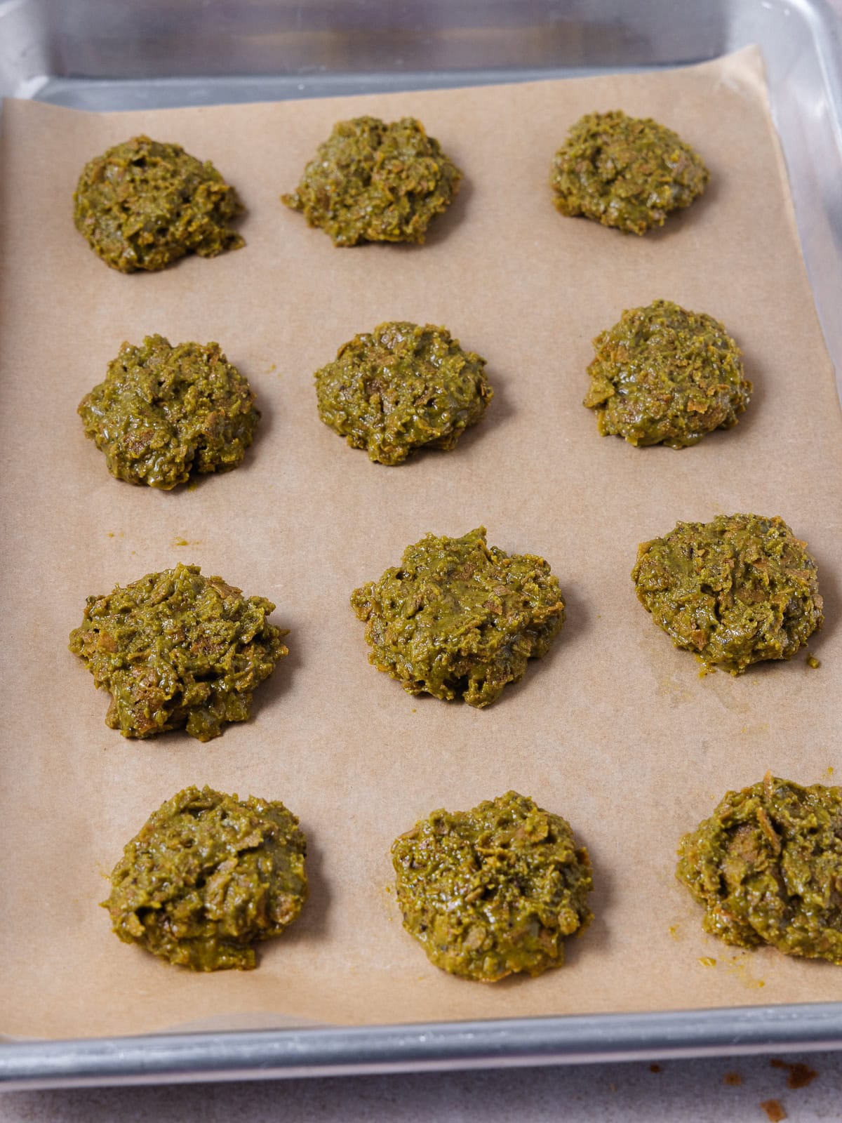 The pistachio butter filling is portioned out to 12 discs.