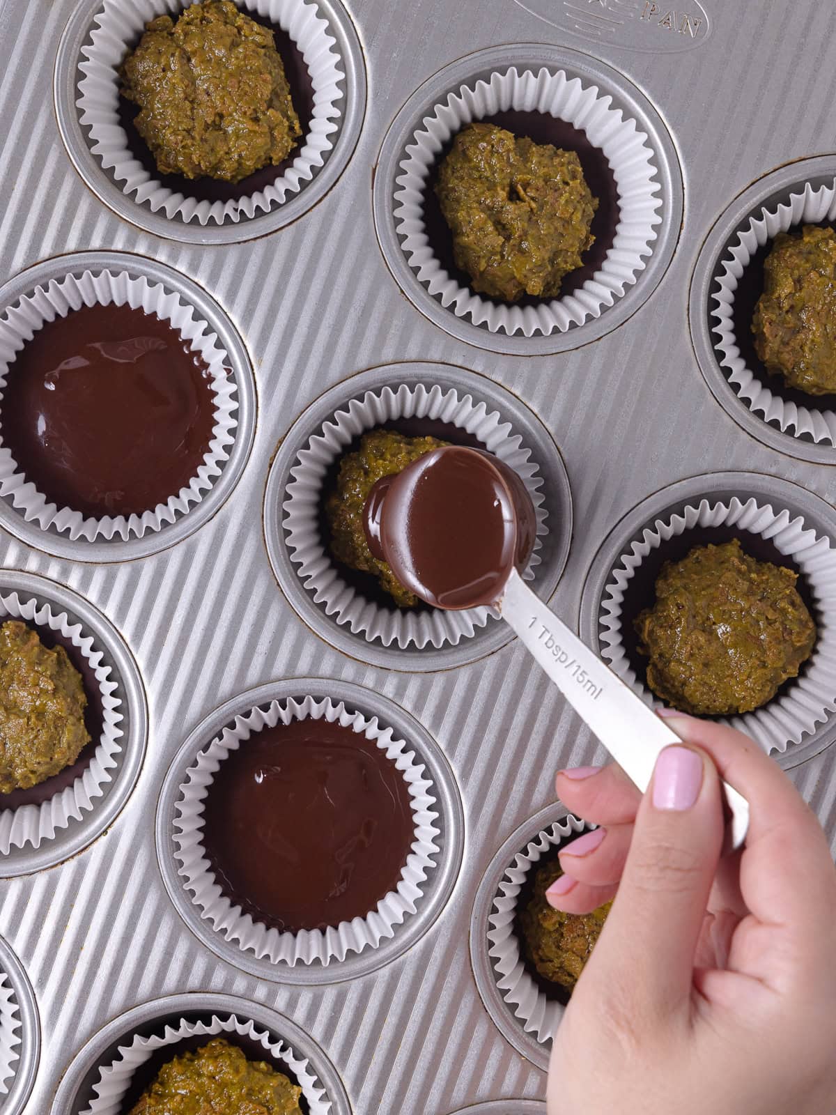 Pistachio butter chocolate cups is topped with top layer of chocolate.