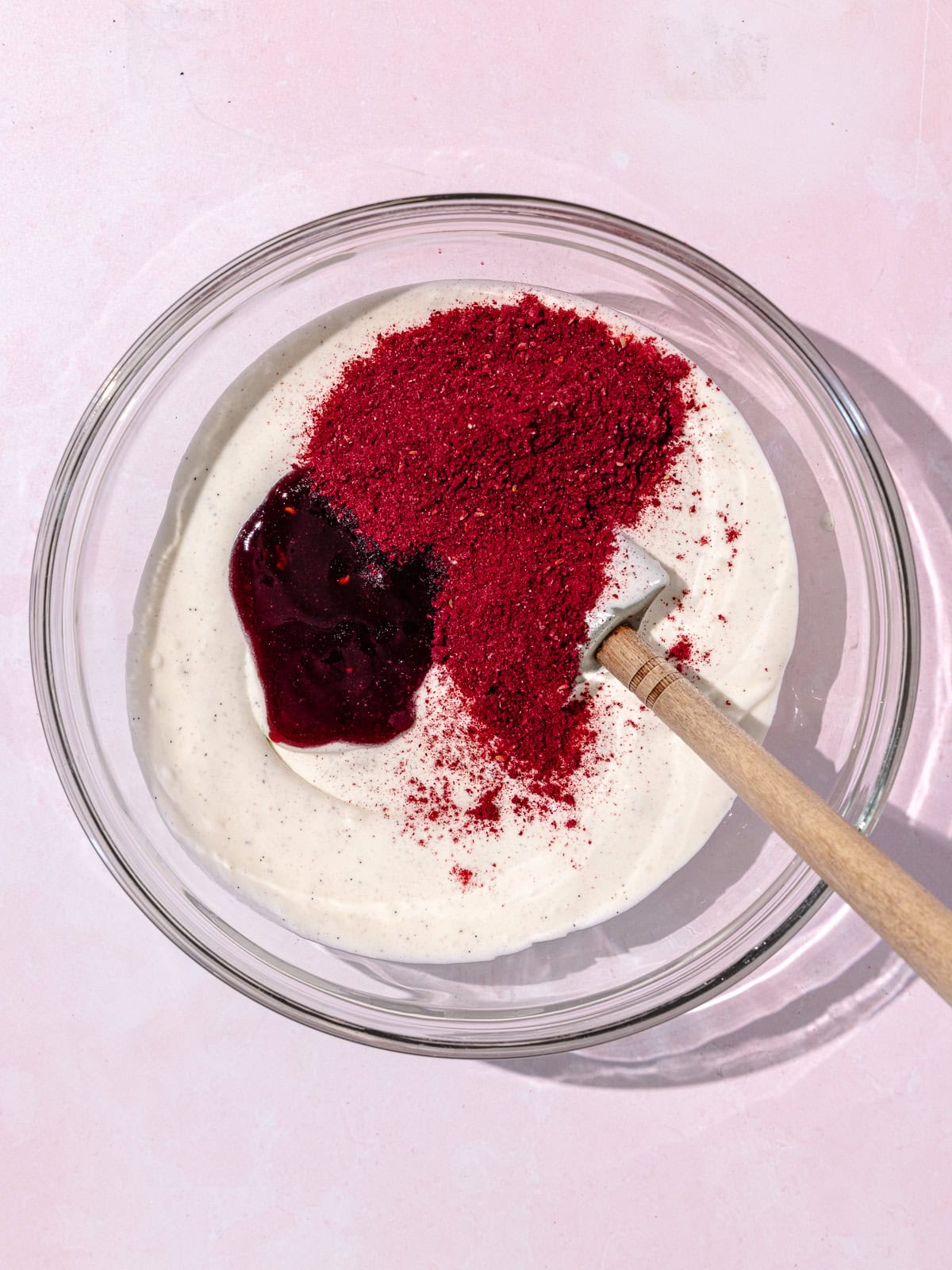 Raspberry jam and freeze-dried raspberry powder is added to the small bowl of vanilla ice cream.