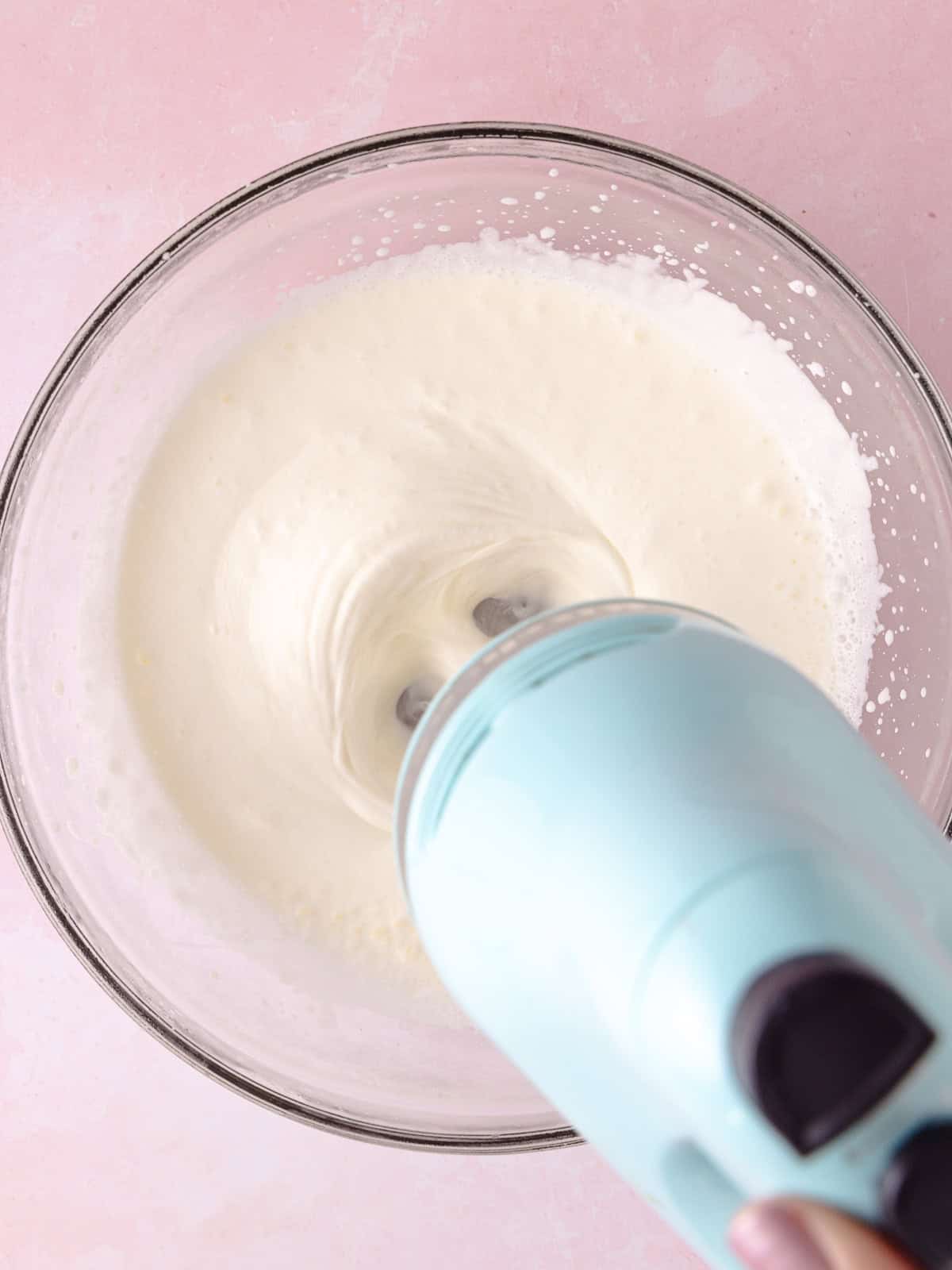 Heavy cream, sweetened condensed milk and vanilla is whipped with a hand mixer.