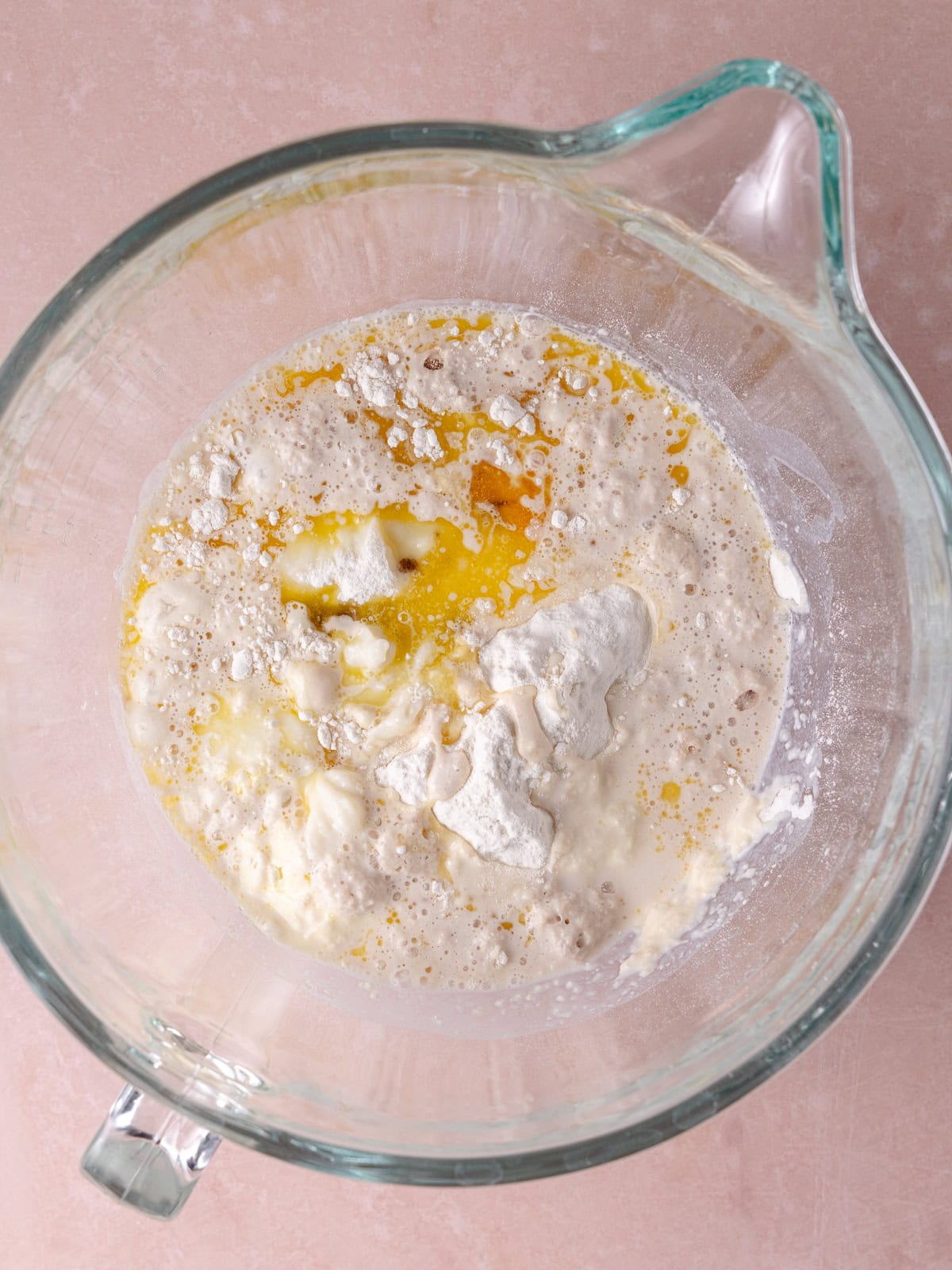 Bread flour, yeast mixture, tangzhong, melted butter, vanilla, egg, brown sugar are in a large mixing bowl.