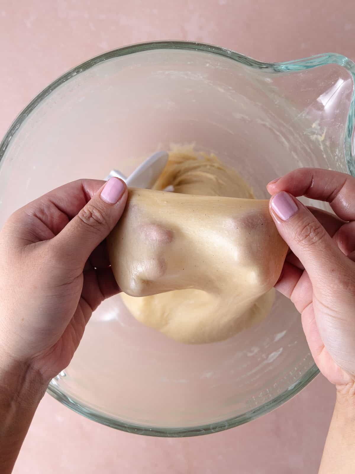 Window pane test is performed by stretching a small patch of dough.