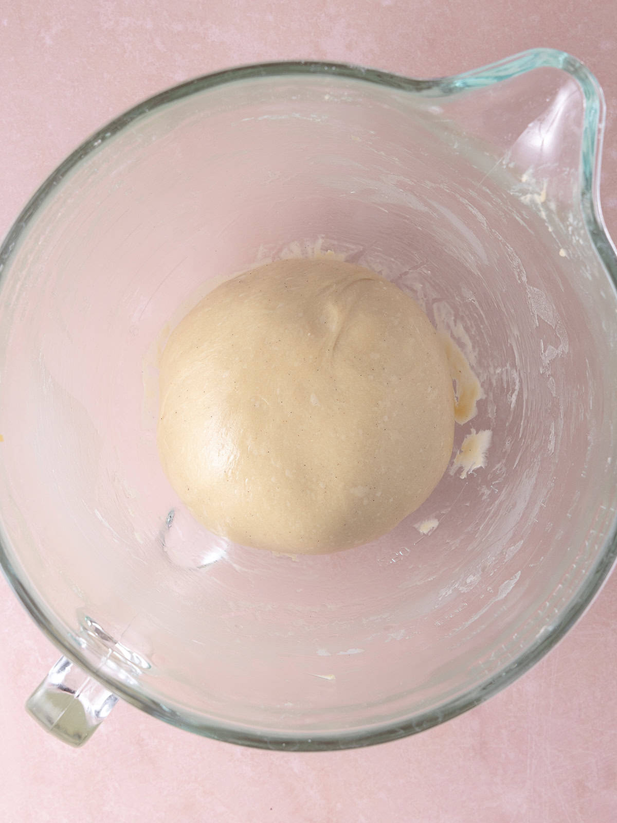 A smooth ball of dough is formed and placed in a oiled bowl.