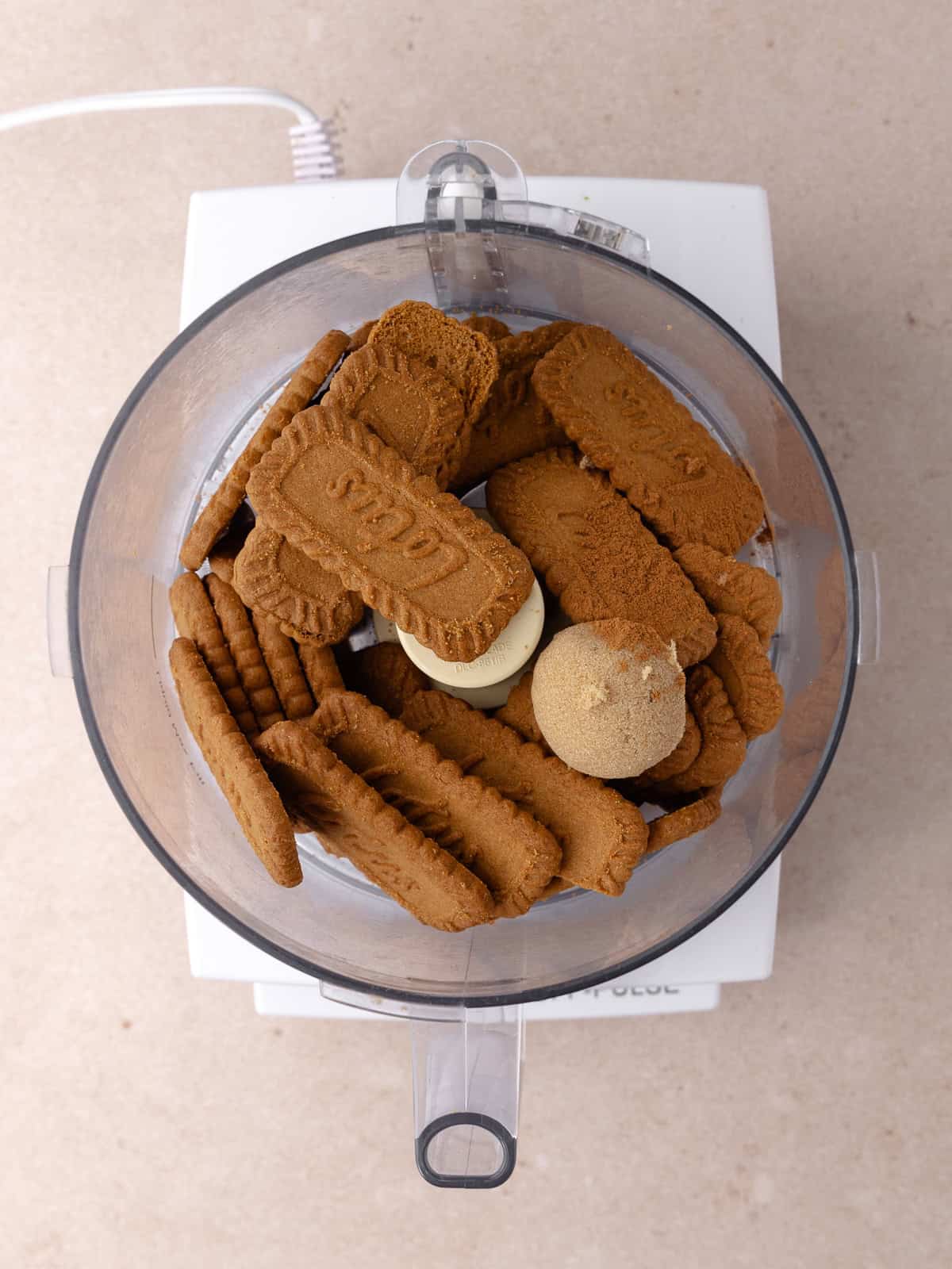 Biscoff cookies, brown sugar and cinnamon are added to a food processor.