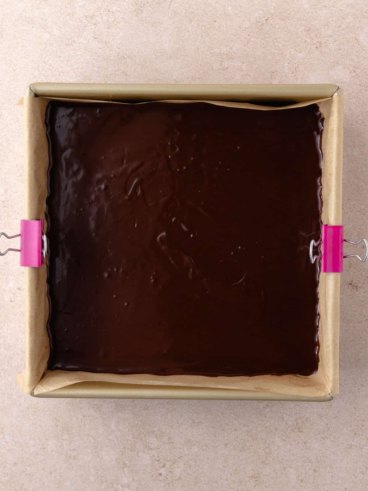 Chocolate ganache layer is added on top of cookies butter layer.