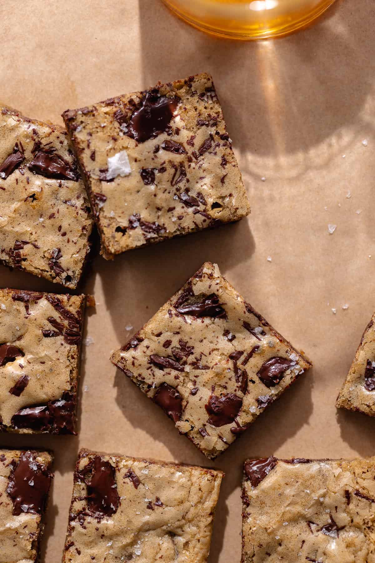 Bourbon blondie squares with a glass of bourbon.