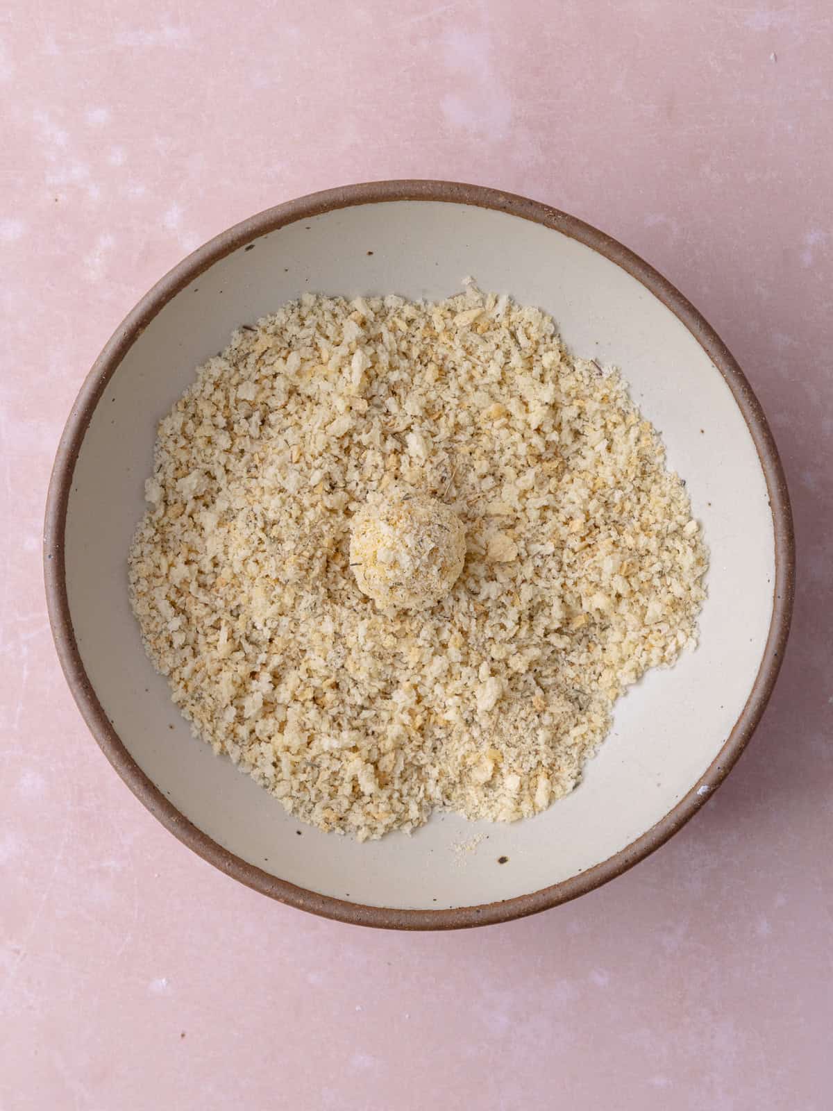 Goat cheese ball is coated in seasoned panko.