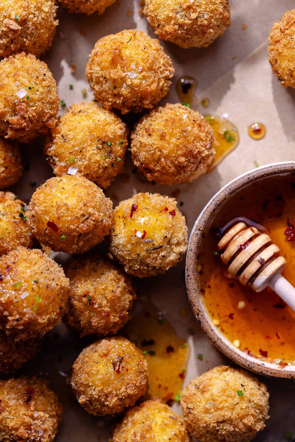 Goat cheese balls on serving tray with hot honey.