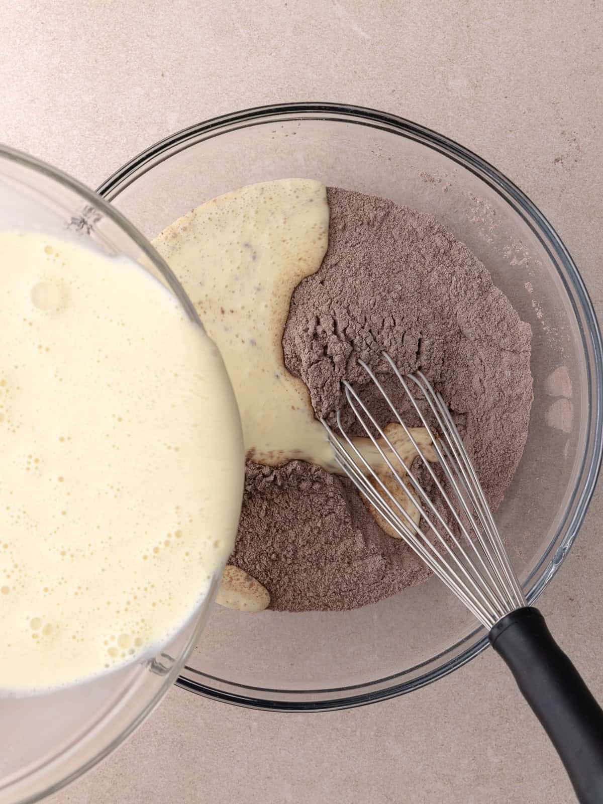 Wet ingredients are poured into the dry ingredients.