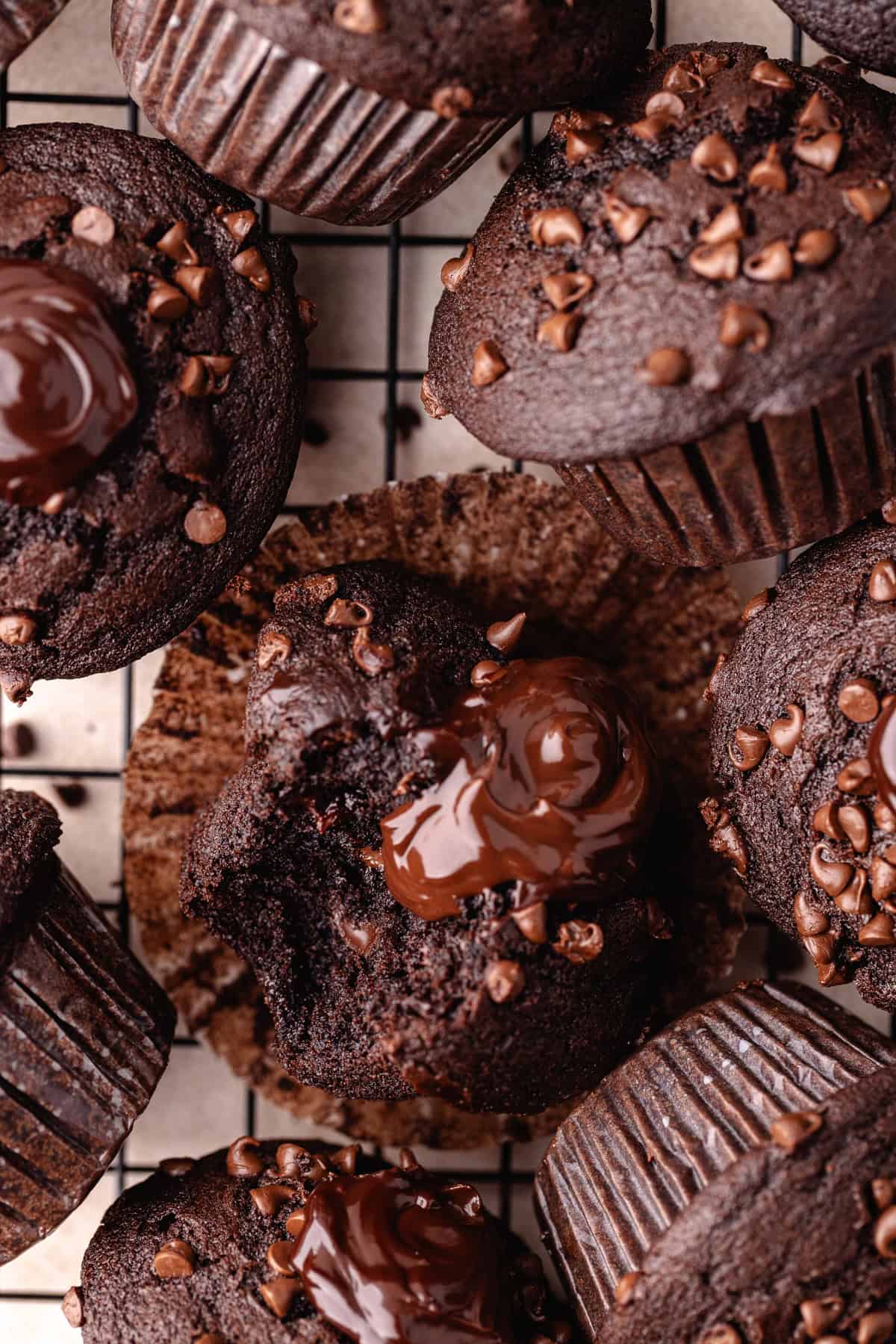 Triple chocolate muffins on a wire rack.