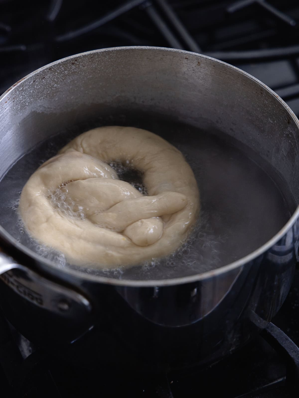 Pretzel is boiled in a boiling baking soda water bath.