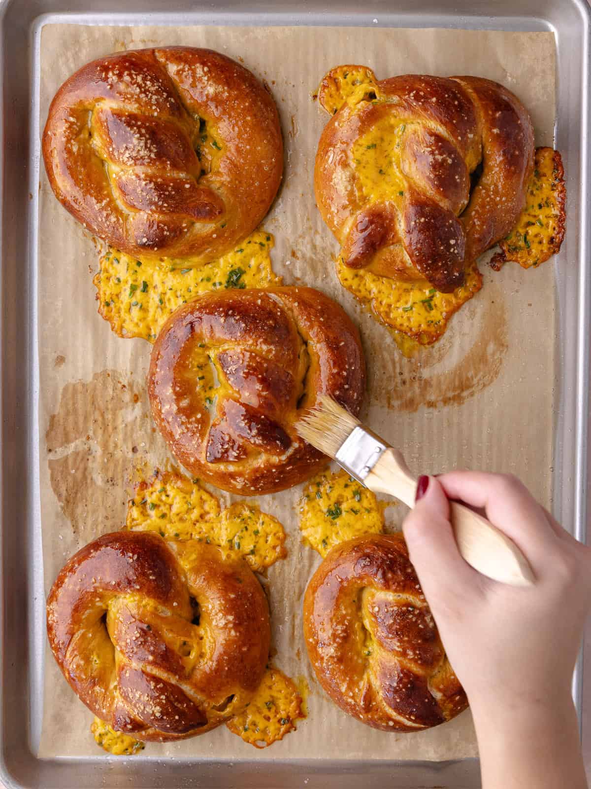 Pretzles get brushed with melted butter as soon as it comes out of the oven.