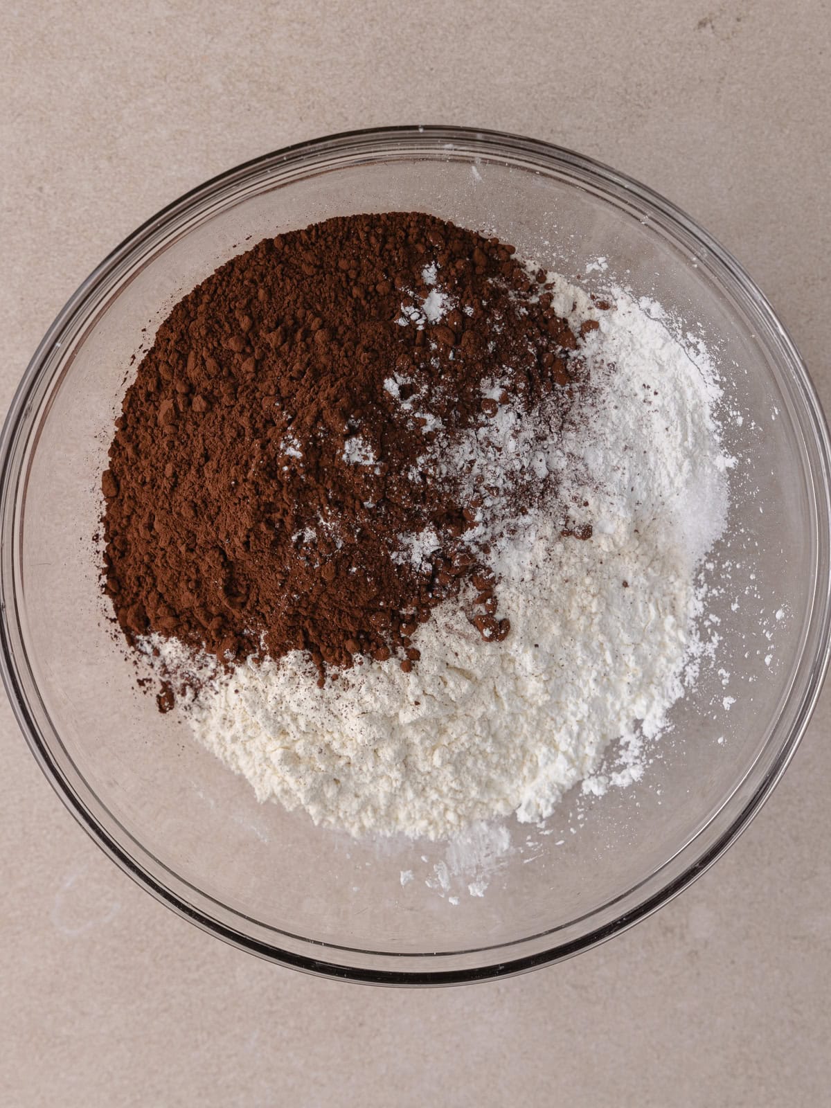 All-purpose flour, cornstarch, cocoa powder, baking powder and salt are in a medium glass mixing bowl.