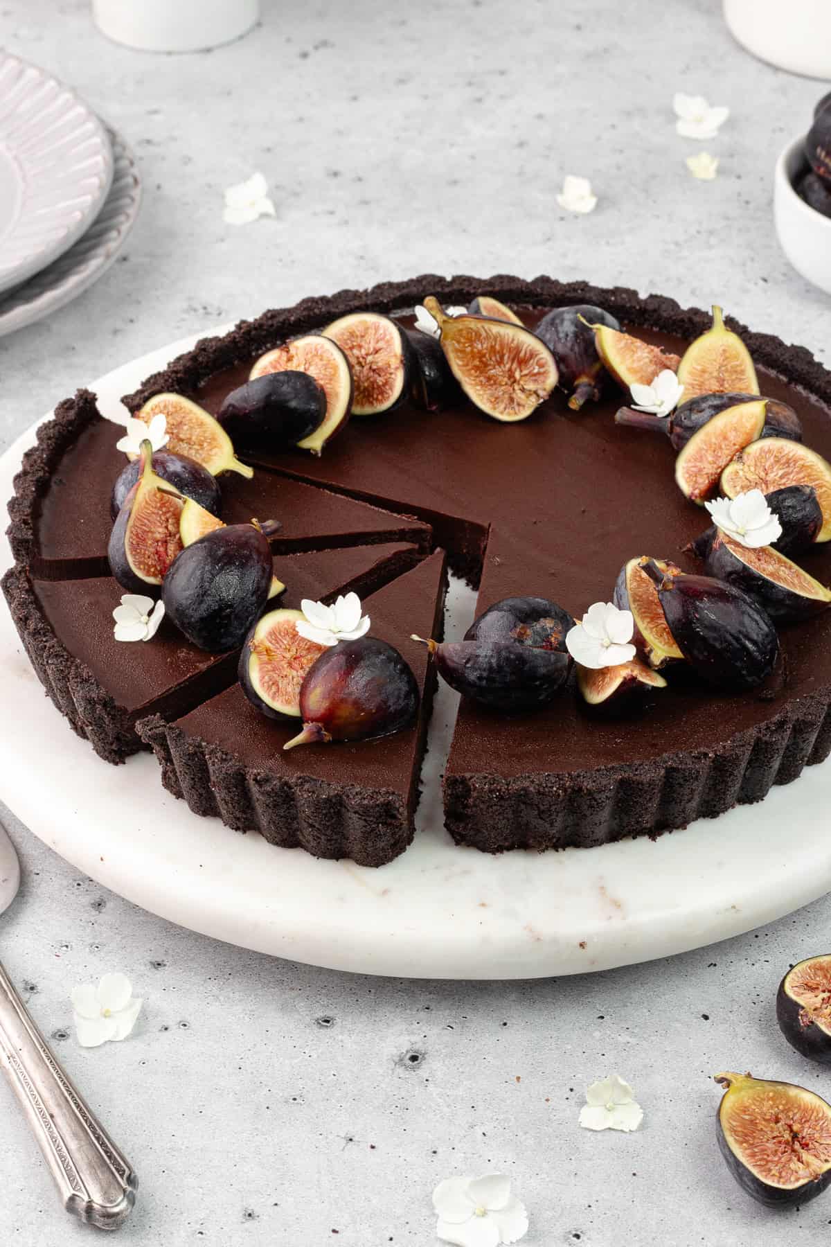 Slices of chocolate earl grey tart on a marble serving plate.