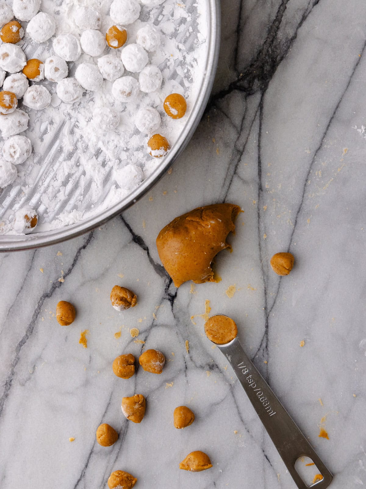 Pumpkin boba balls are portioned with a ⅛th measuring spoon.