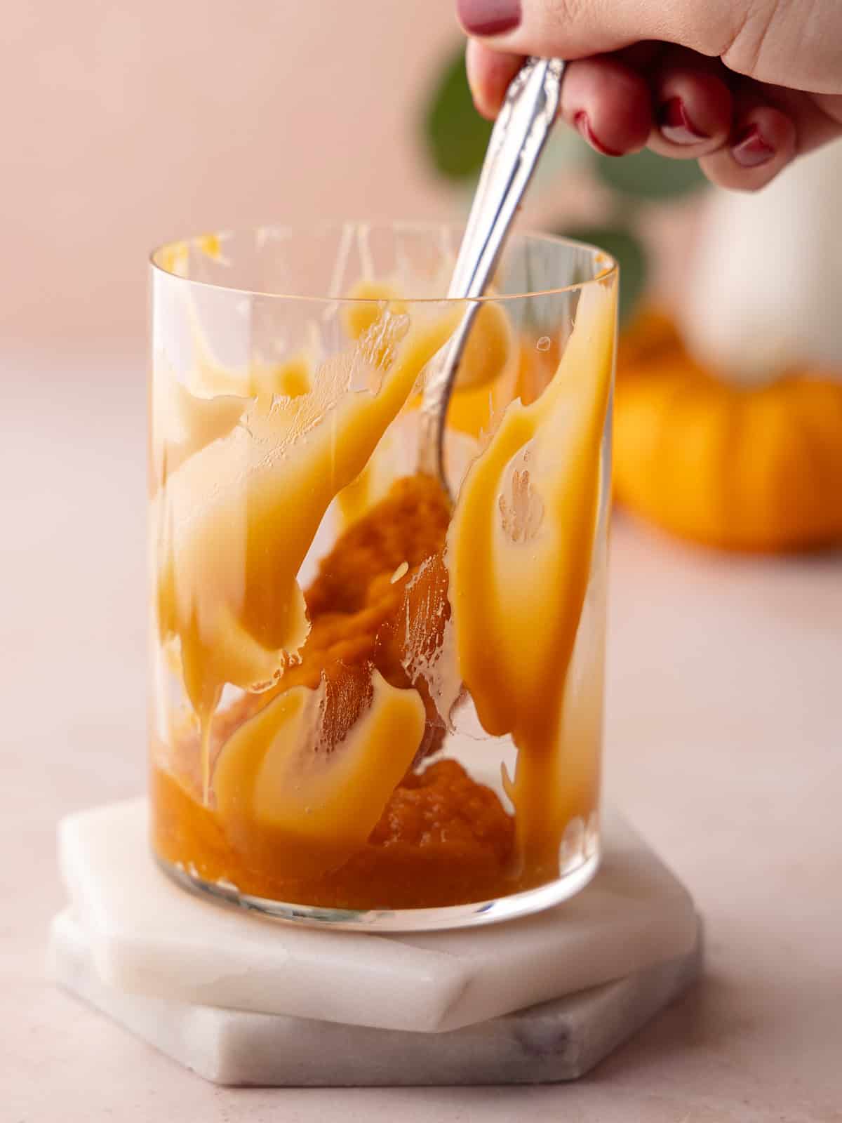 Pumpkin puree is added to glass.