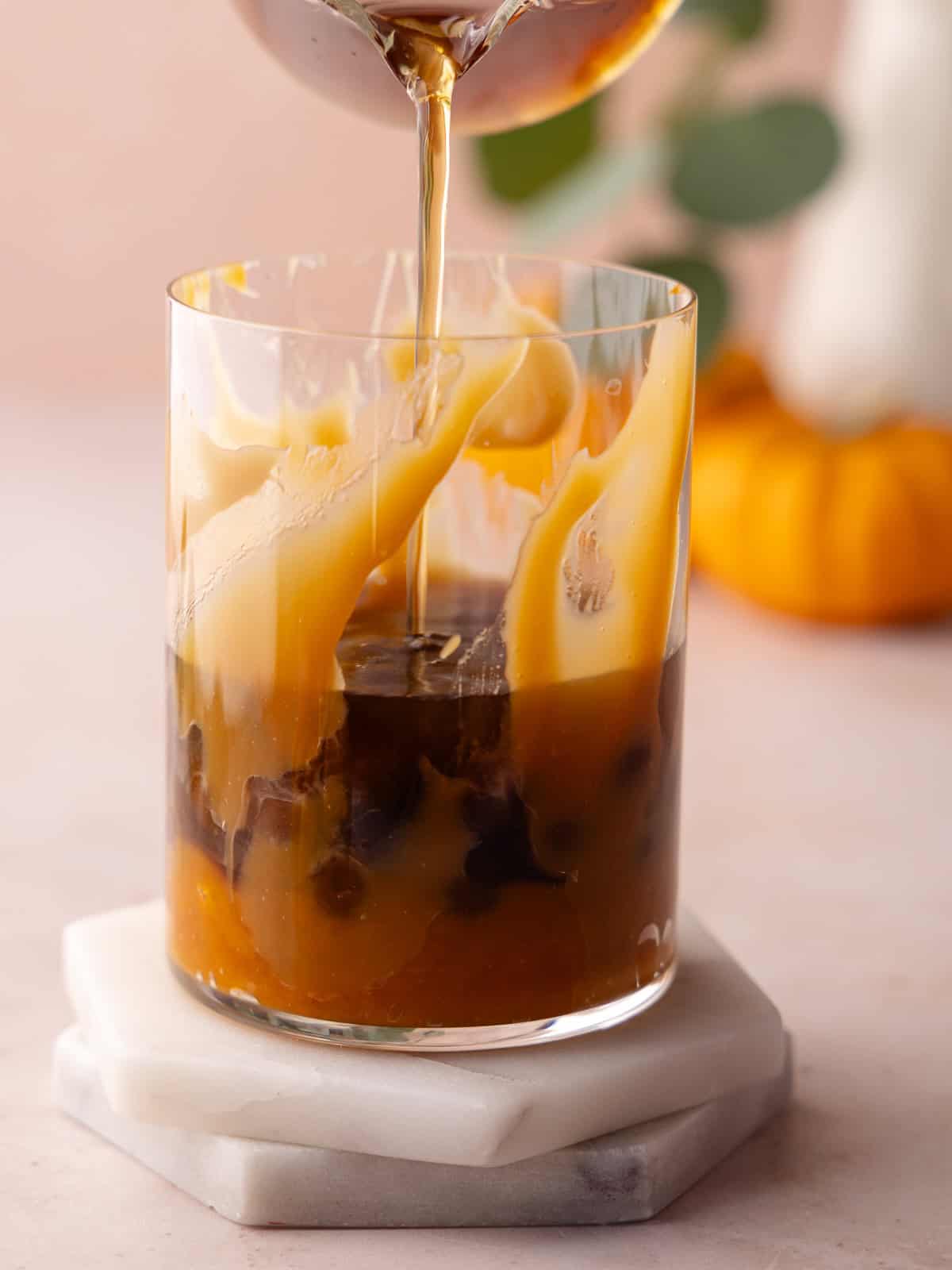 Tea is poured into glass.