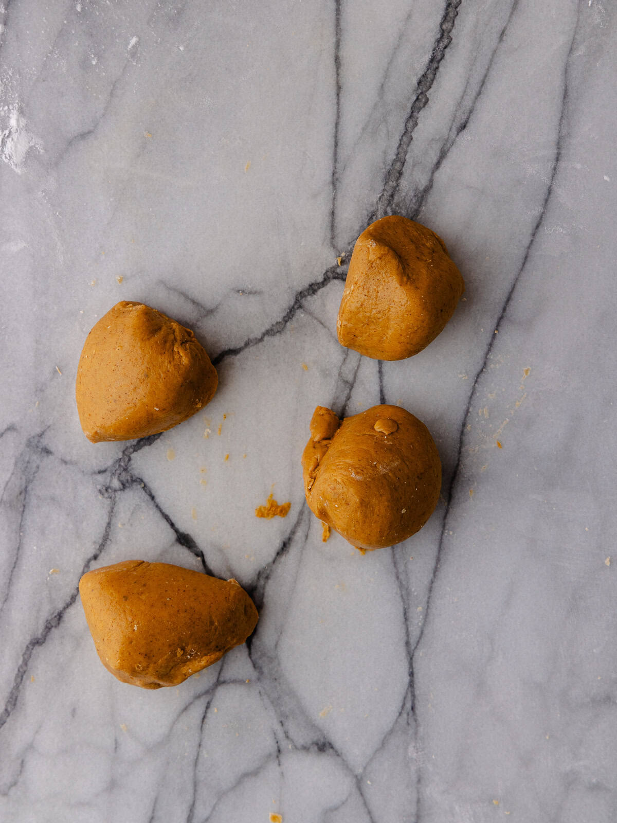 Pumpkin boba dough are portioned into 4 small balls.