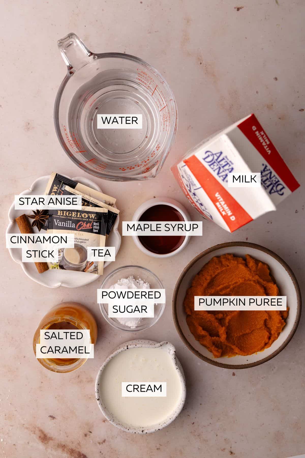 Pumpkin tea ingredients which include, mik, tea, cinnamon, star anise, maple syrup, pumpkin puree, cream, powdered sugar, salted caramel.