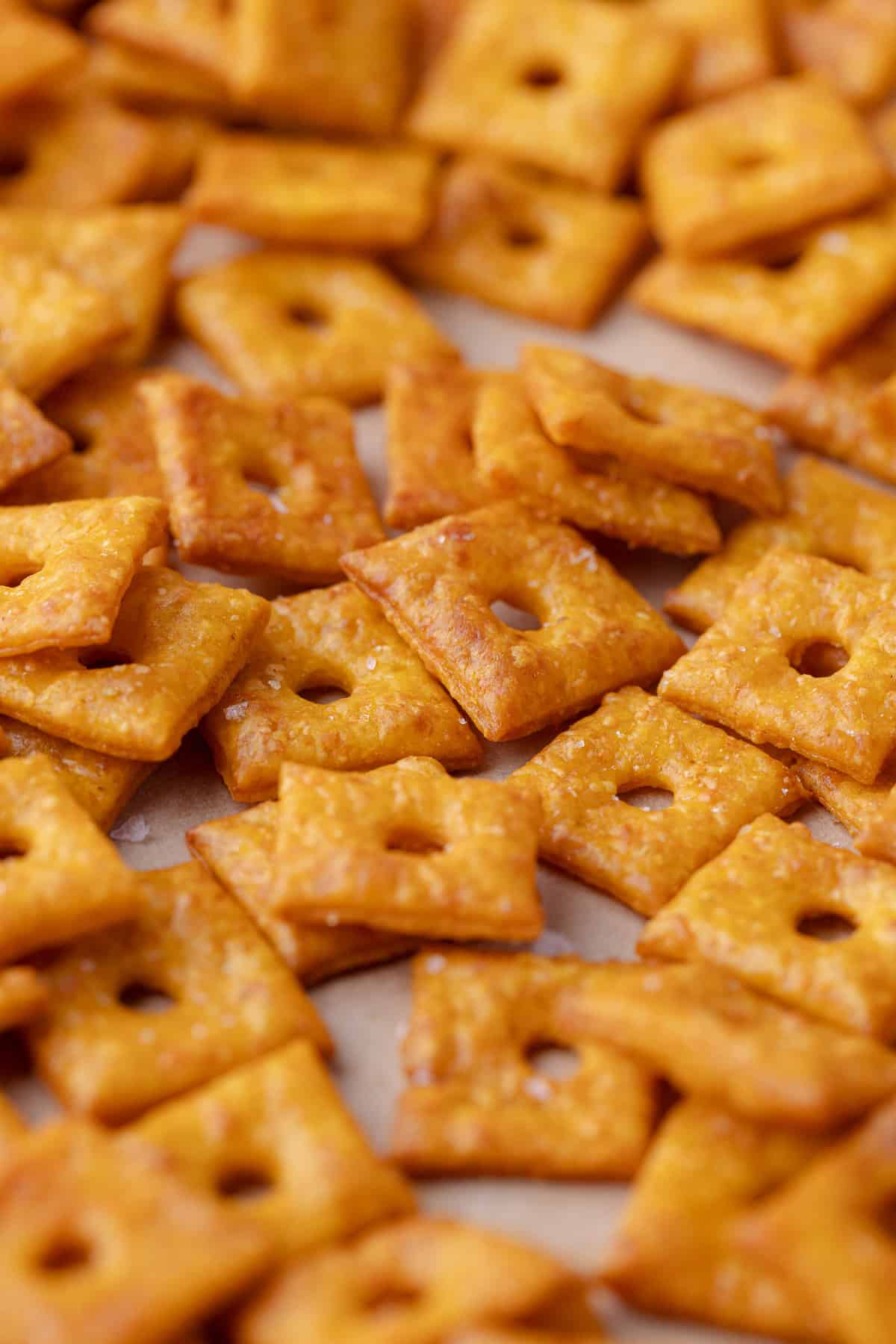 A large pile of pumpkin cheddar crackers.