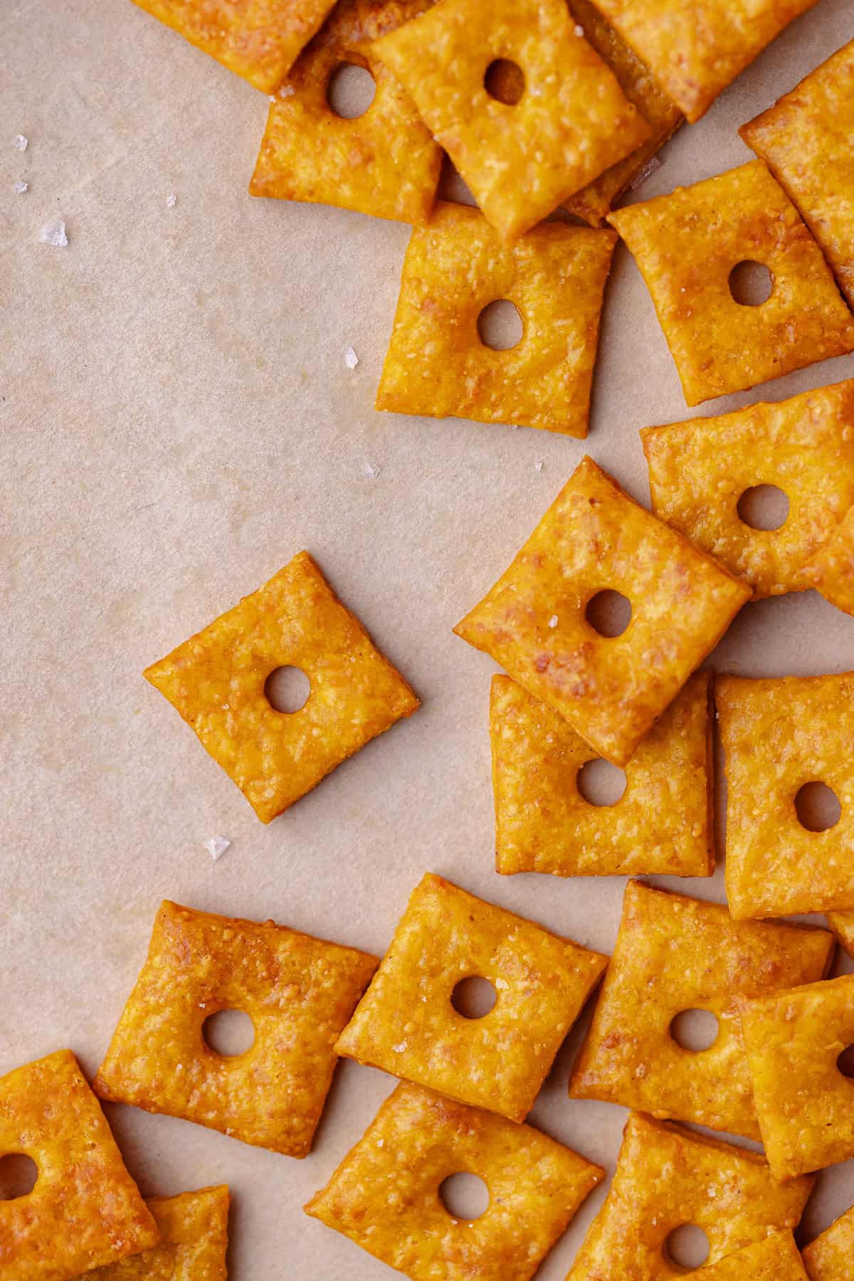 A flatlay of a large of pumpkin cheddar crackers.