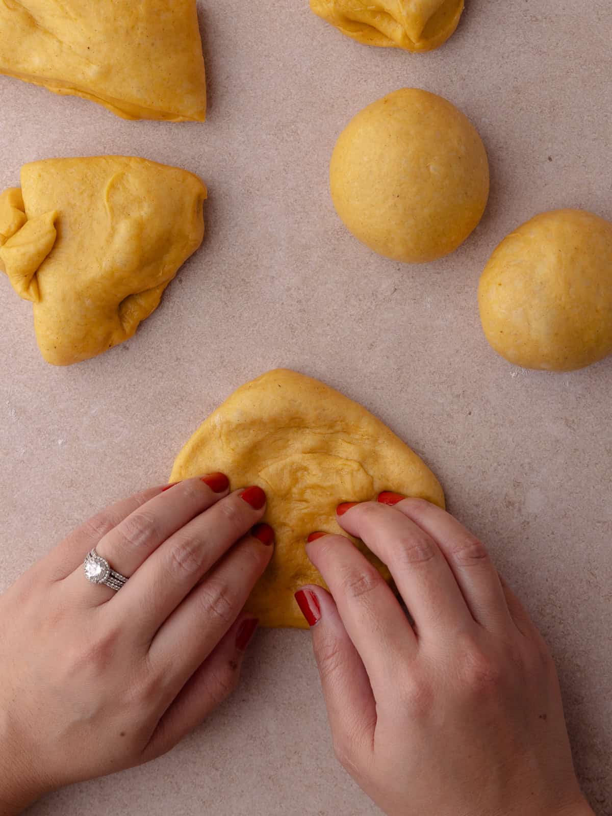 The ball of dough is pressed to release any air bubbles.