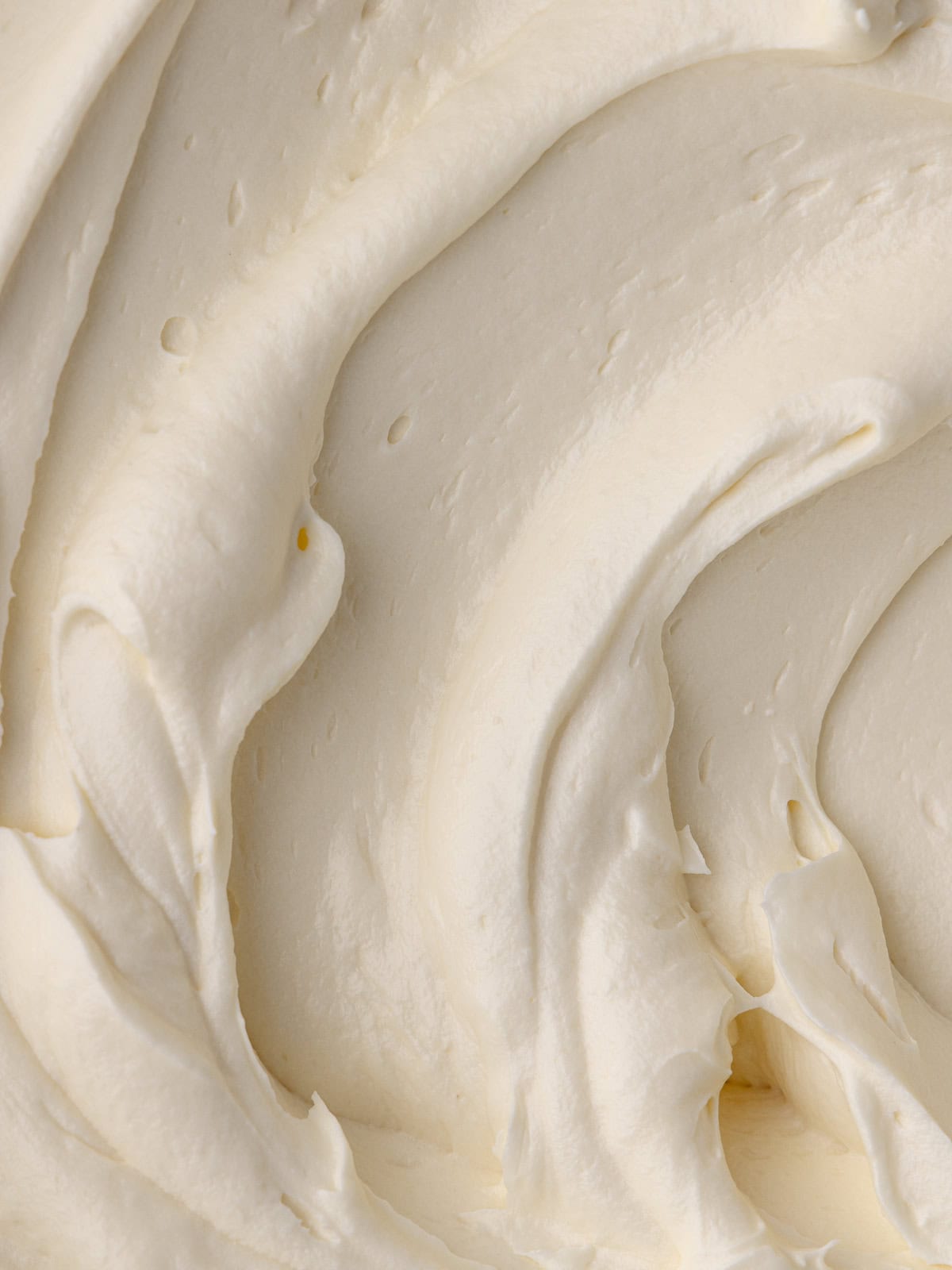 An extreme close up of maple cream cheese frosting.