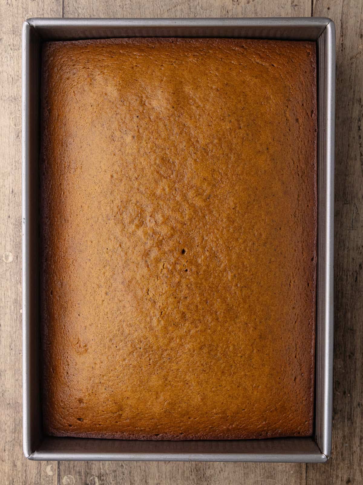 Chai pumpkin cake is fully baked and sitting in the baking pan.