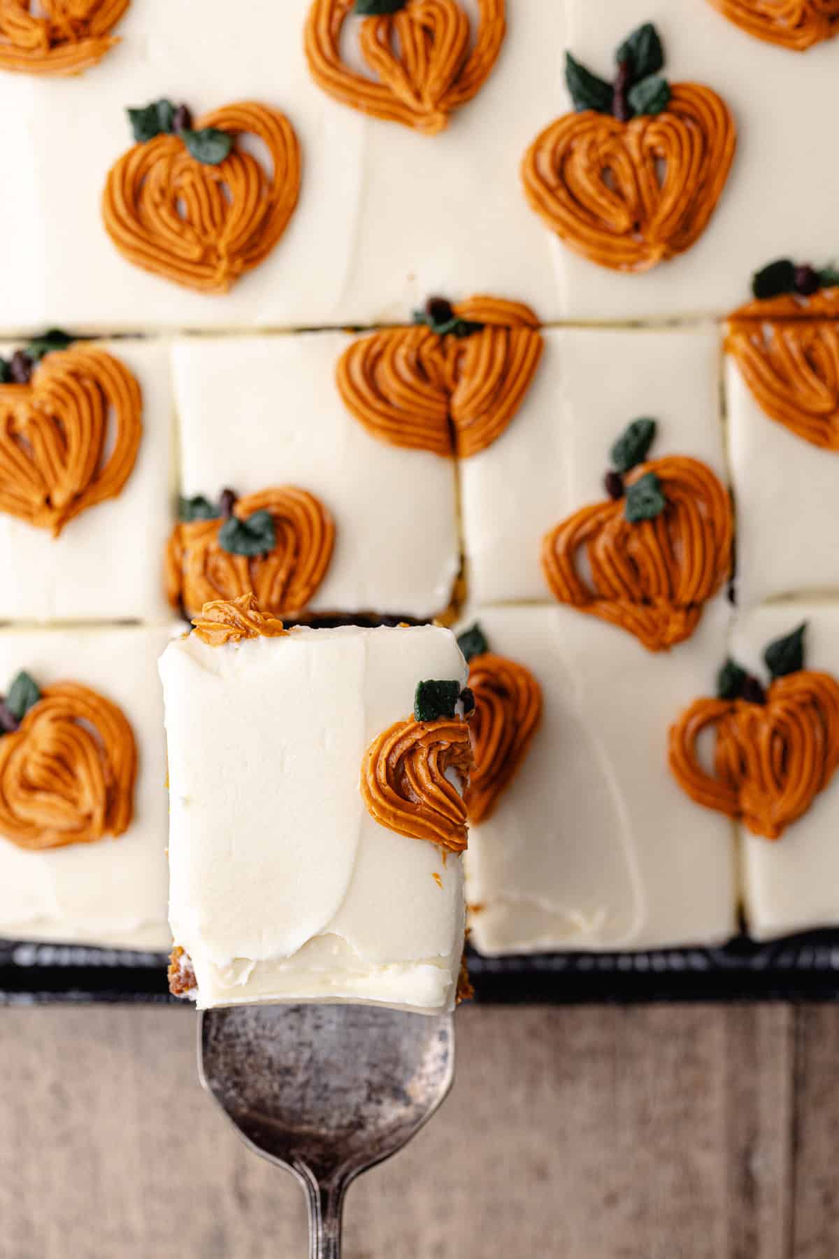 A cake cutter holds a small slice of pumpkin chai cake.